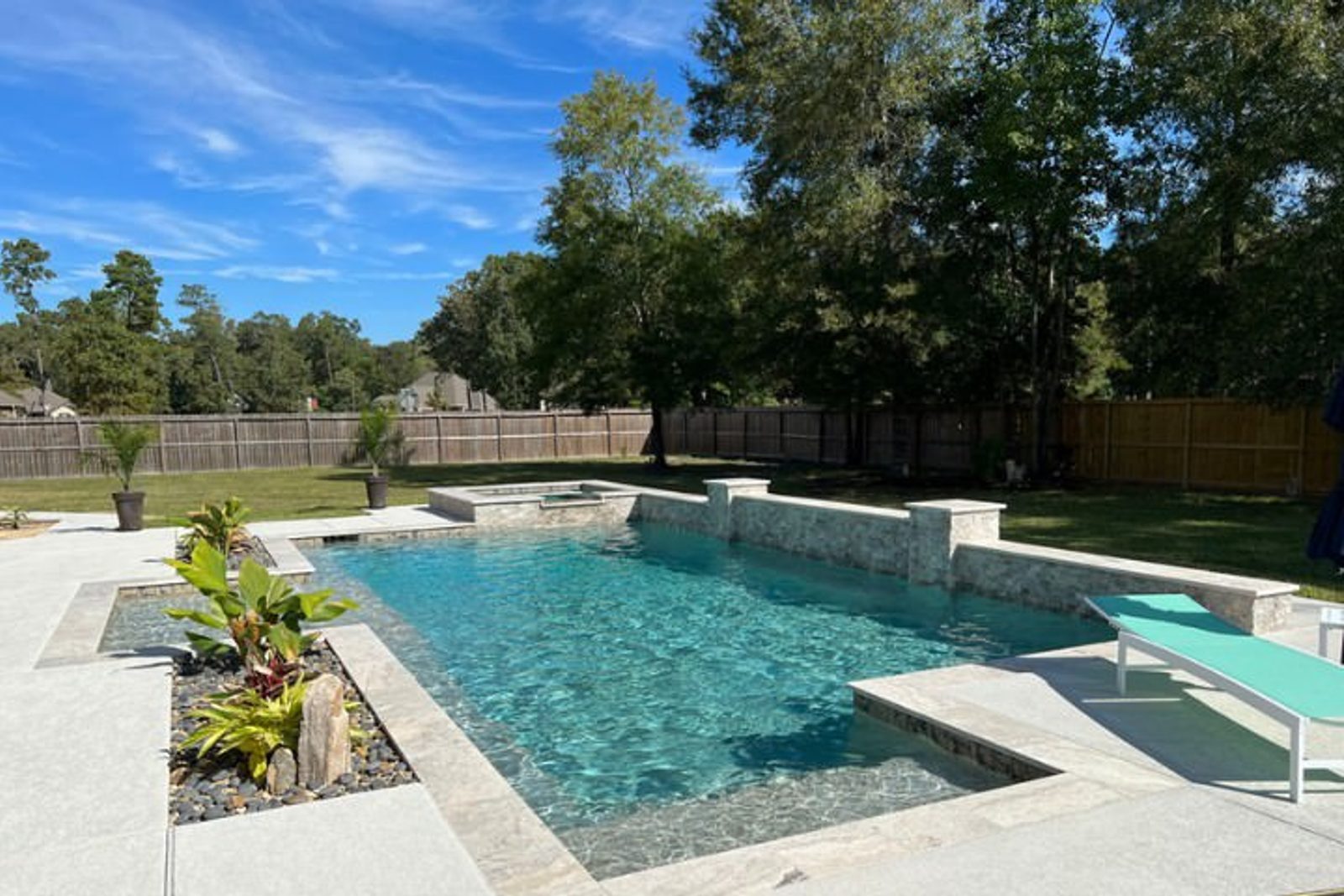Climate-friendly ornamental plants beautifully arranged around a luxury pool in Houston