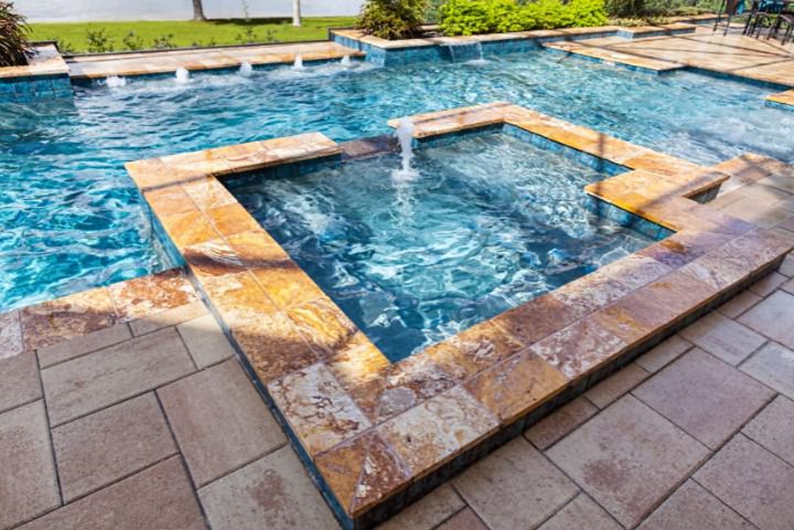 Swimming pool featuring a floating fountain with synchronized water patterns