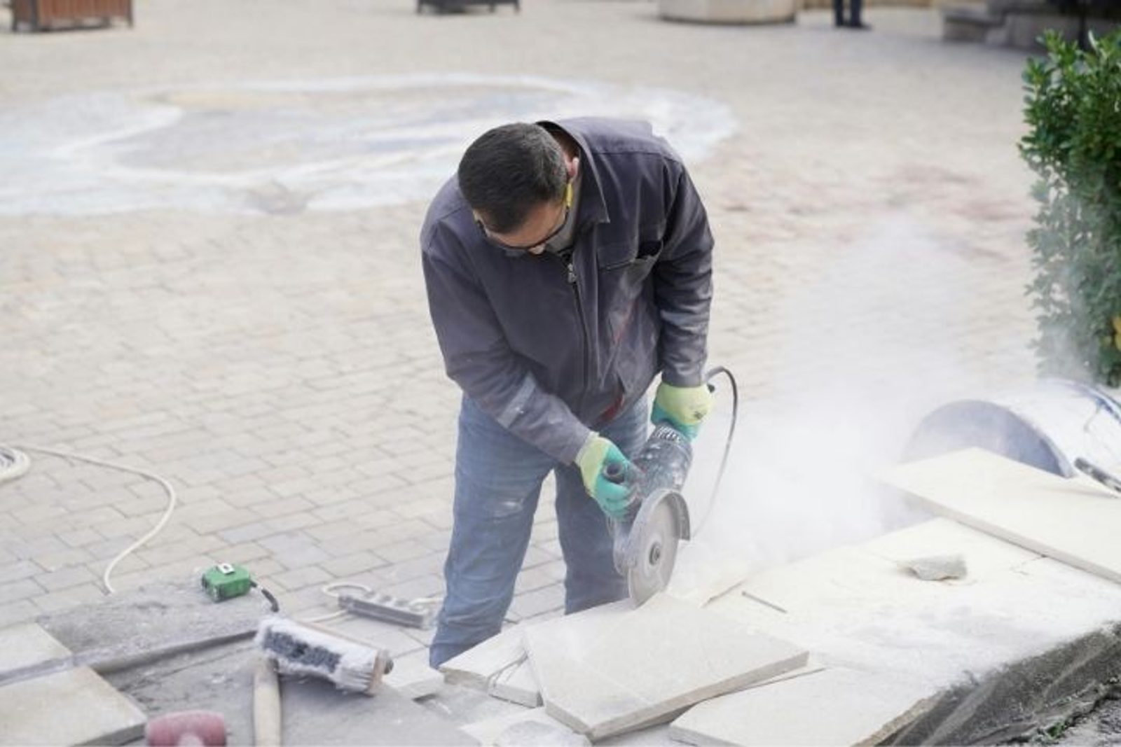 Houston outdoor kitchen contractor cutting materials on a residential construction site