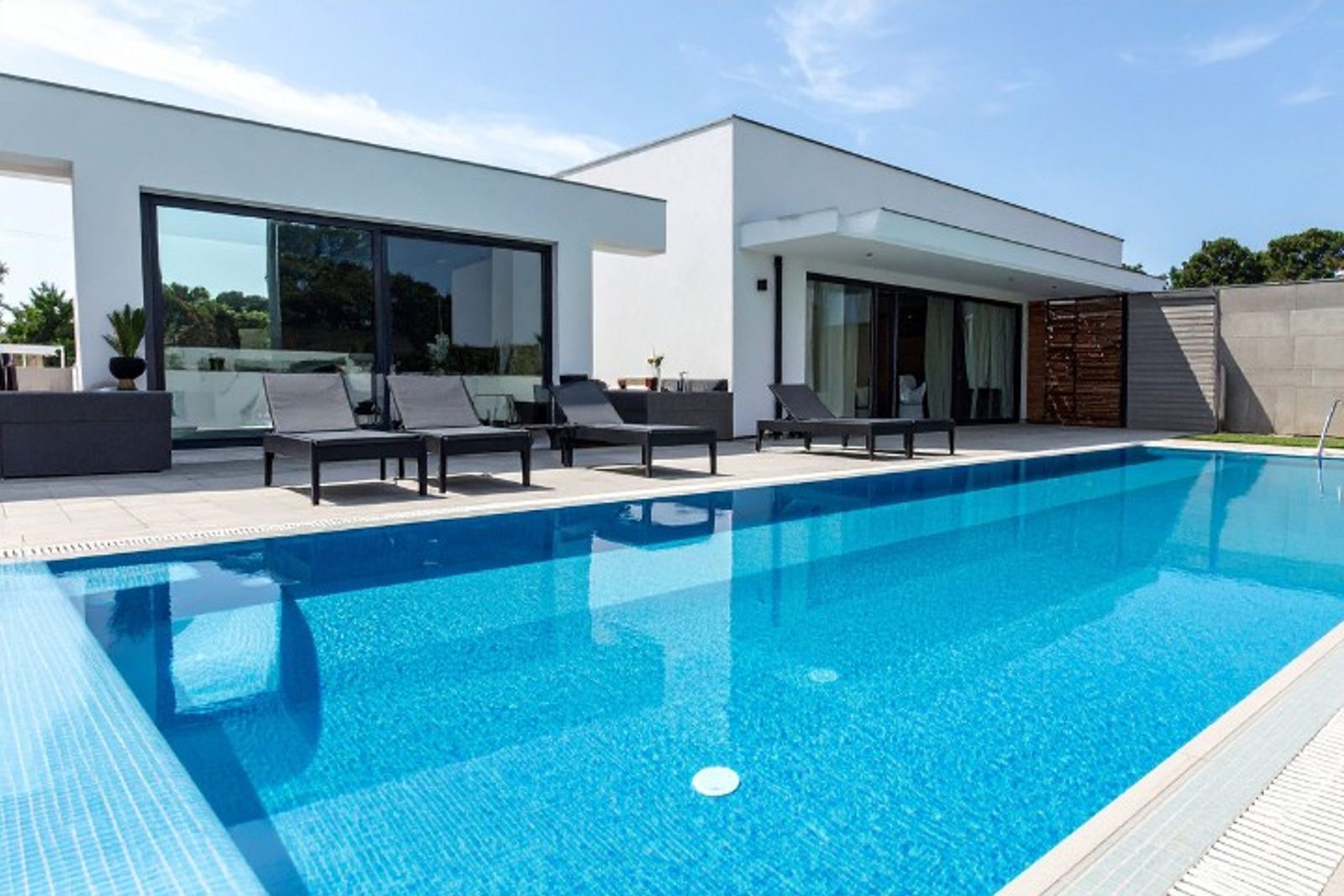 Custom modern swimming pool featuring an anti entrapment drain safety feature