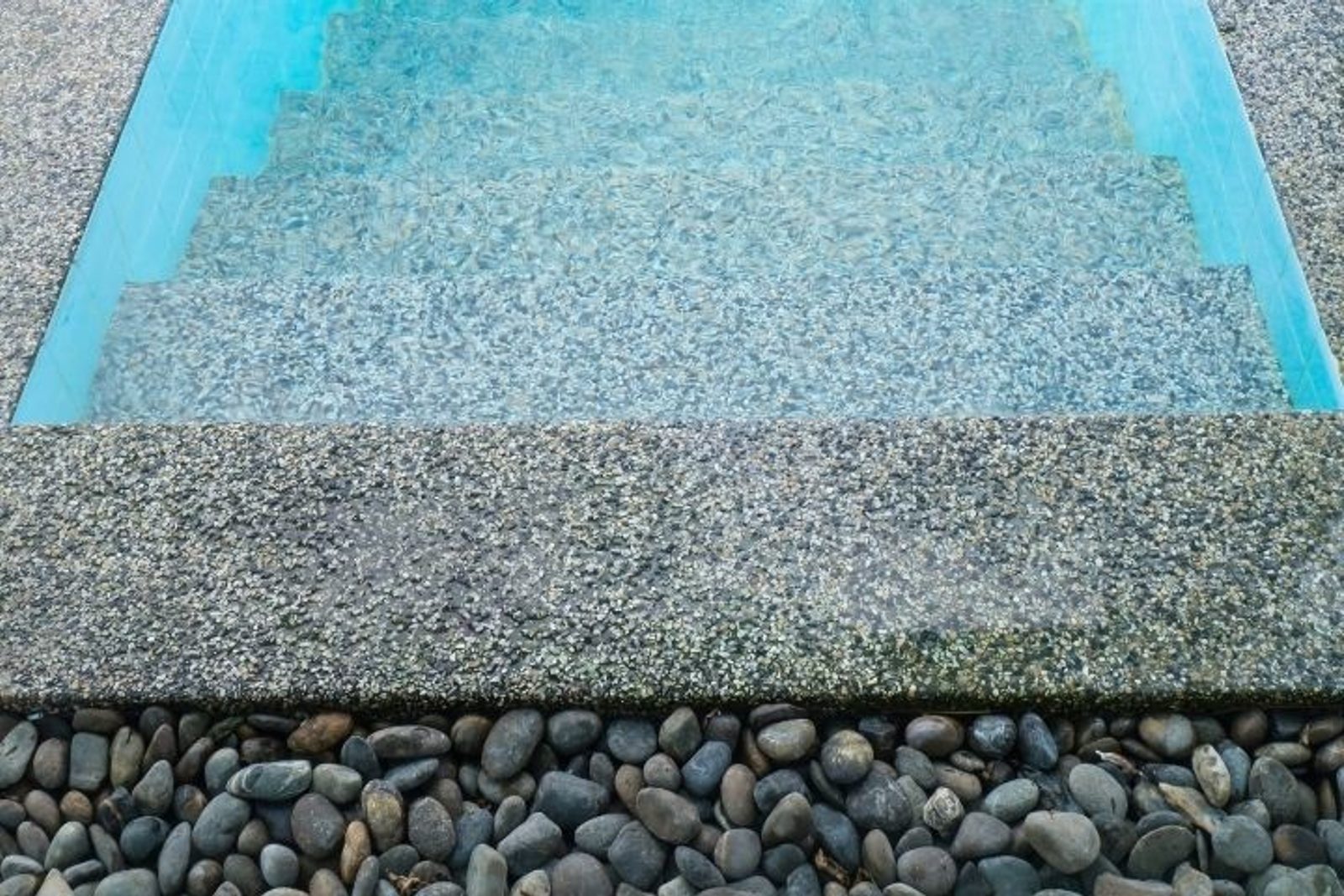 Pebble pool finish showing its natural stone texture under water
