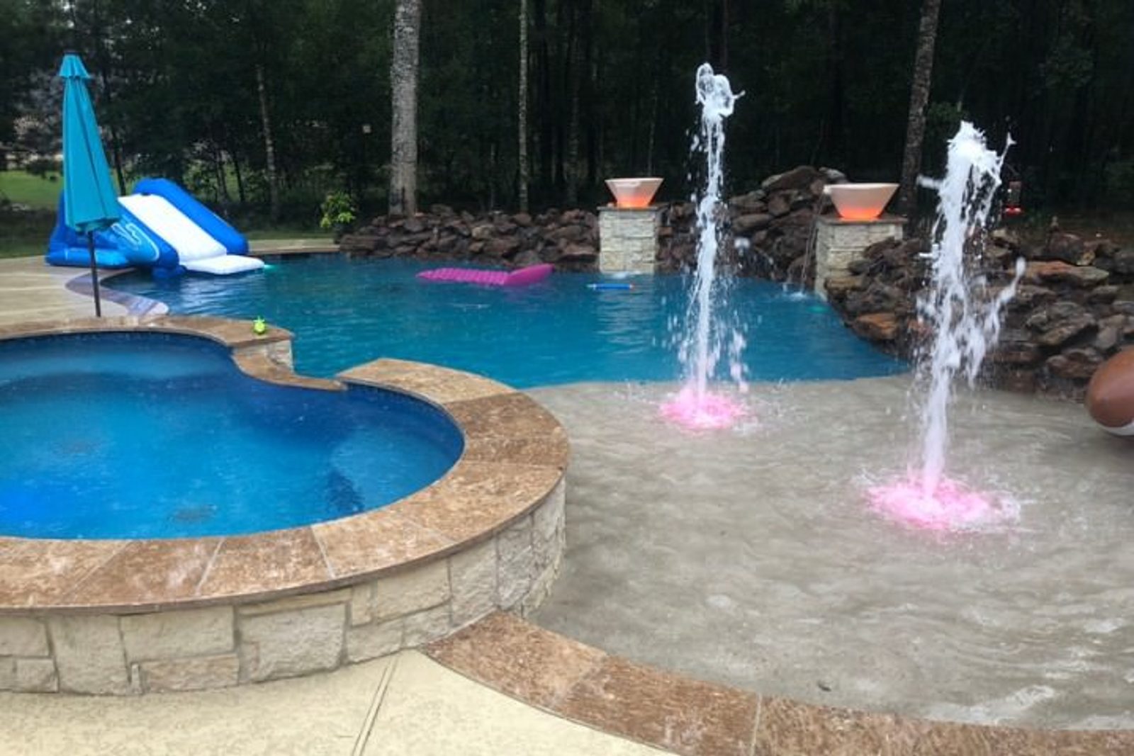 Luxury pool with water fountains creating a dynamic and visually appealing water display