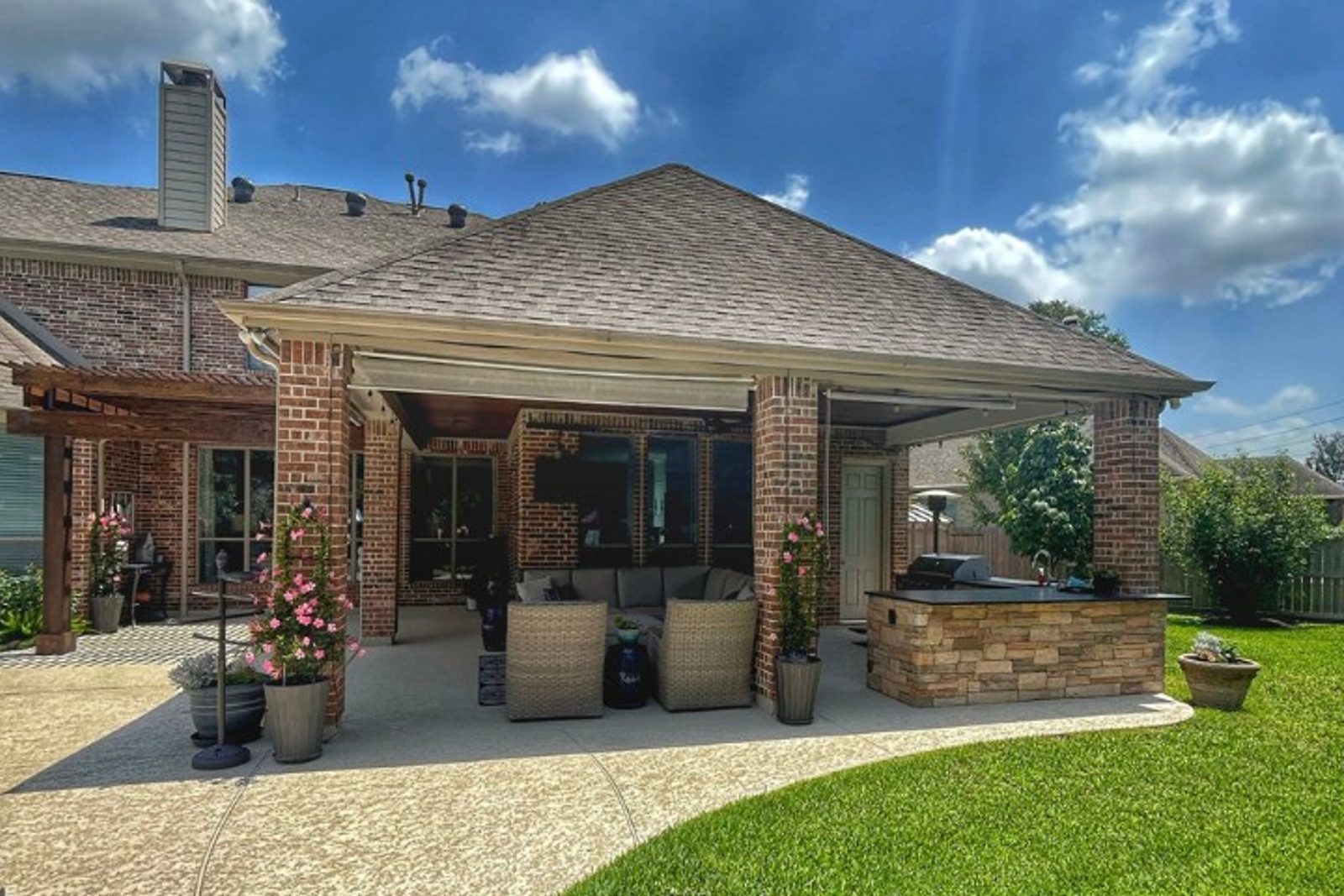 Mediterranean-inspired outdoor living space with arched ceiling and classic brick accents