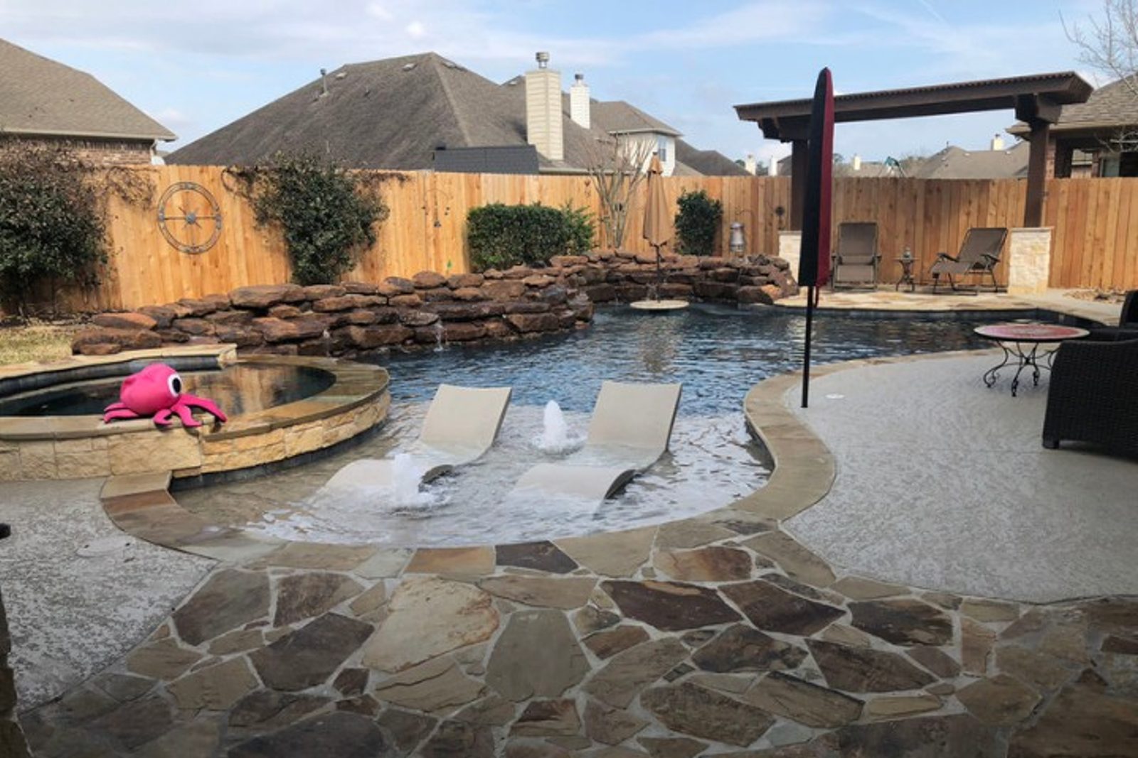 Elegant outdoor living space in Houston with durable stone materials and pool water features