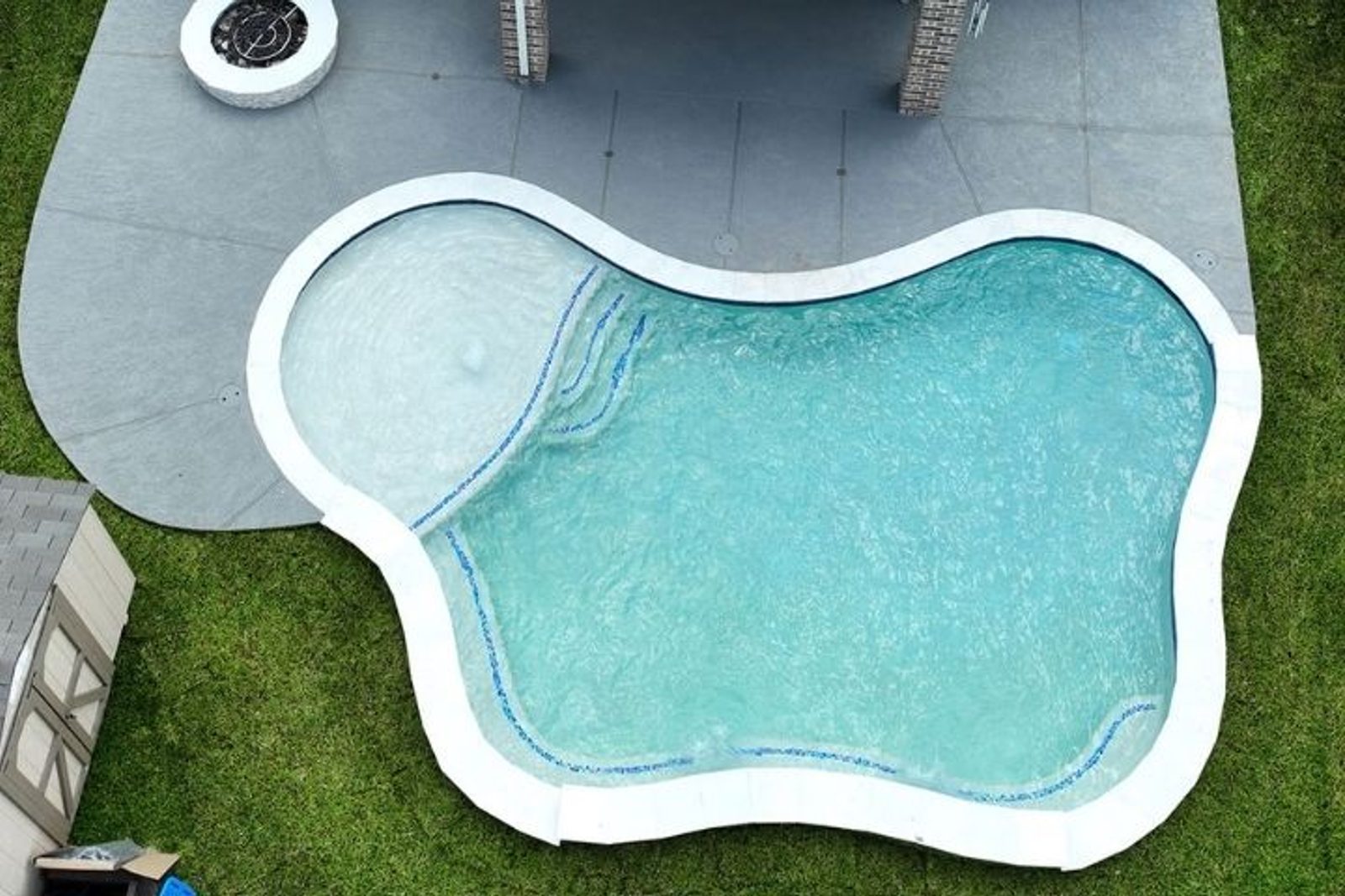 Light plaster pool finish creating a bright blue and aqua water appearance