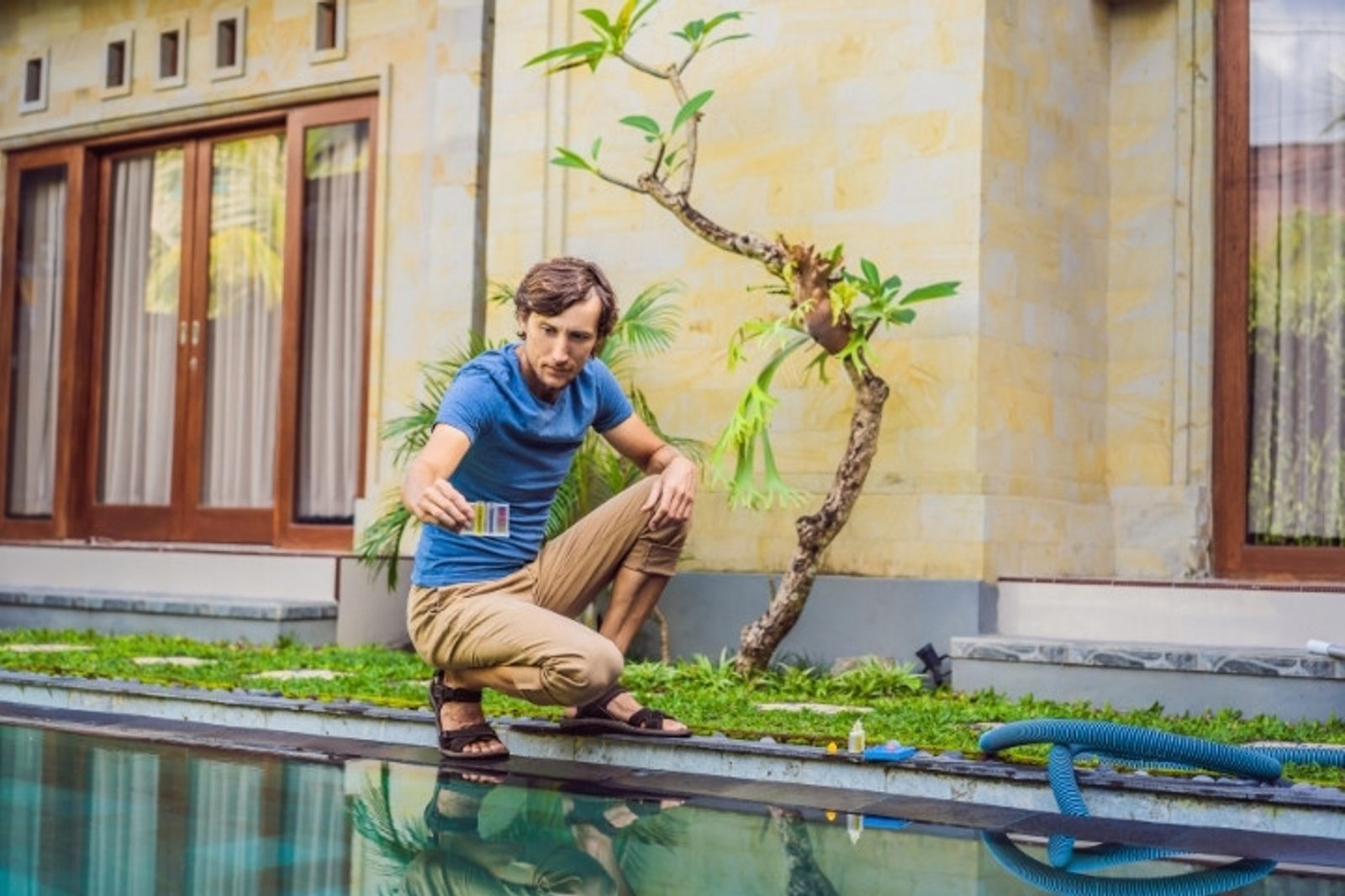 Pool owner testing pool water chemistry
