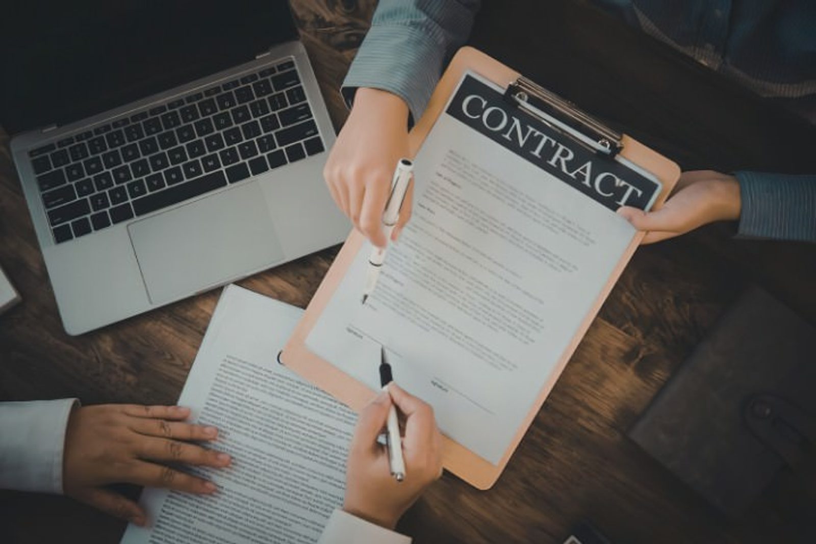 Homeowner and contractor discussing contract details before signing