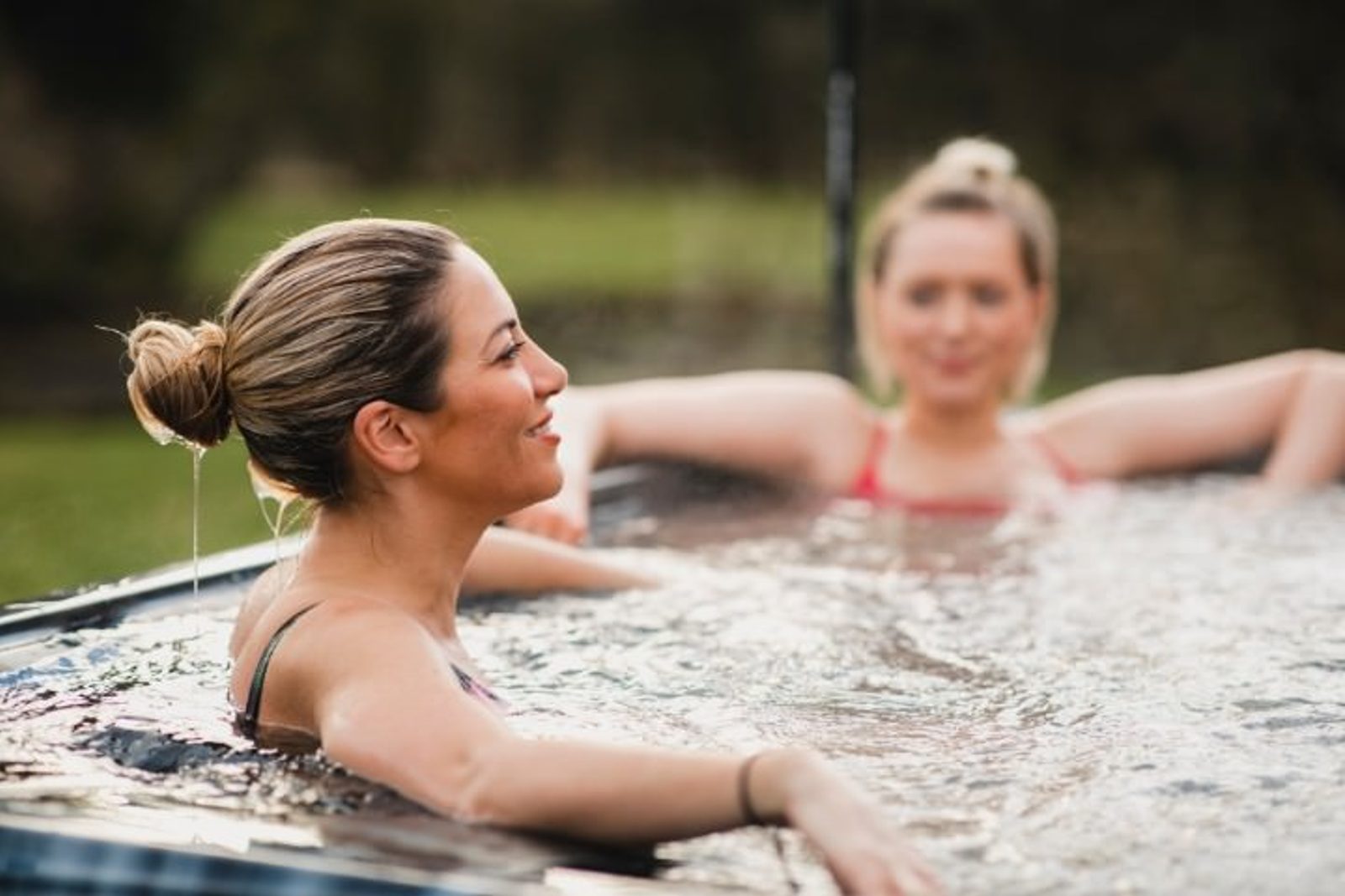 Houston homeowner relaxing in heated outdoor spa with friends
