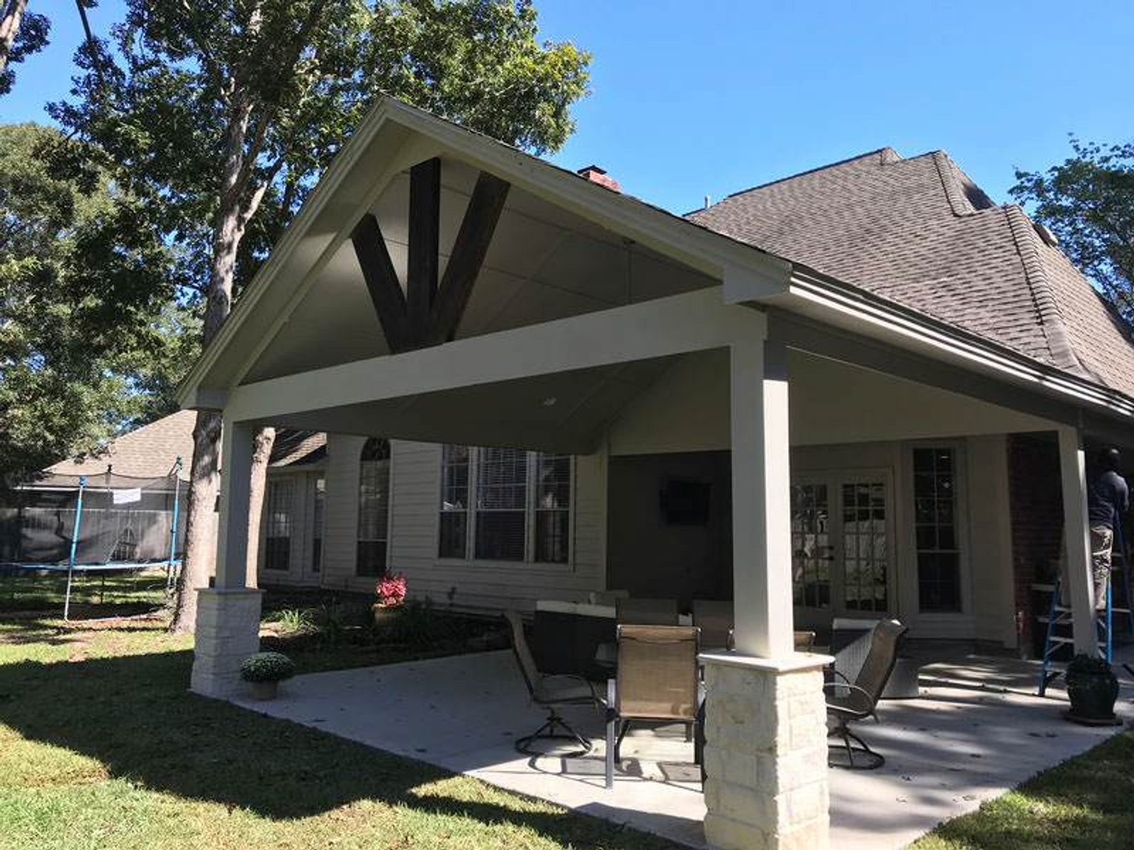 Covered backyard patio with outdoor seating area in Houston