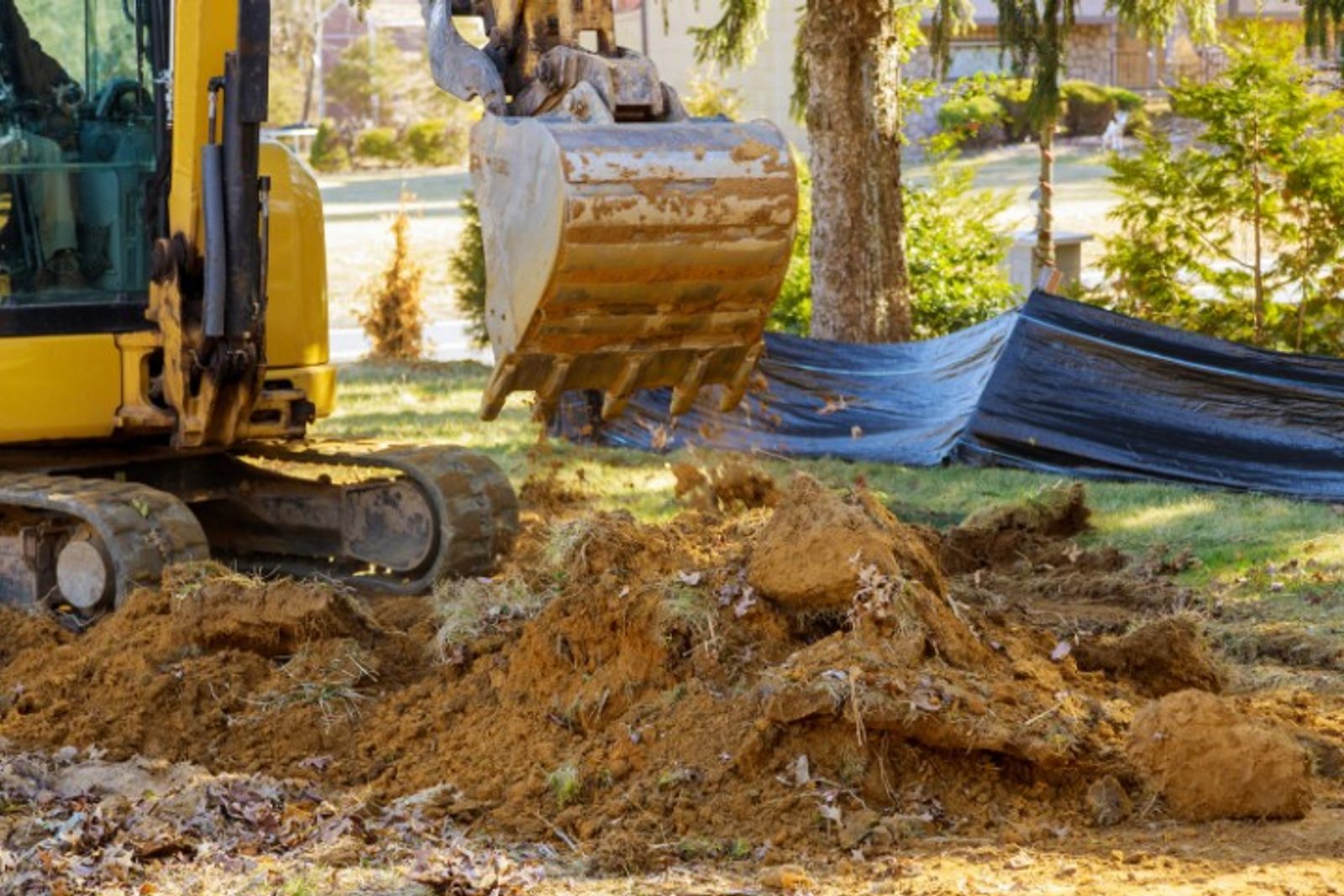 Excavator preparing site for custom pool construction