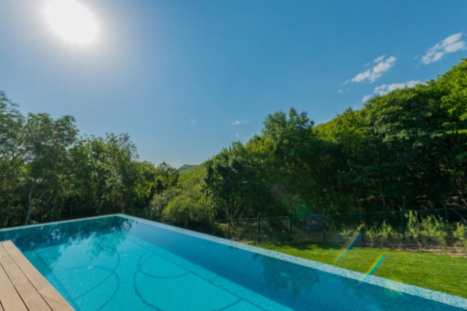 Luxury backyard renovation with infinity pool installation