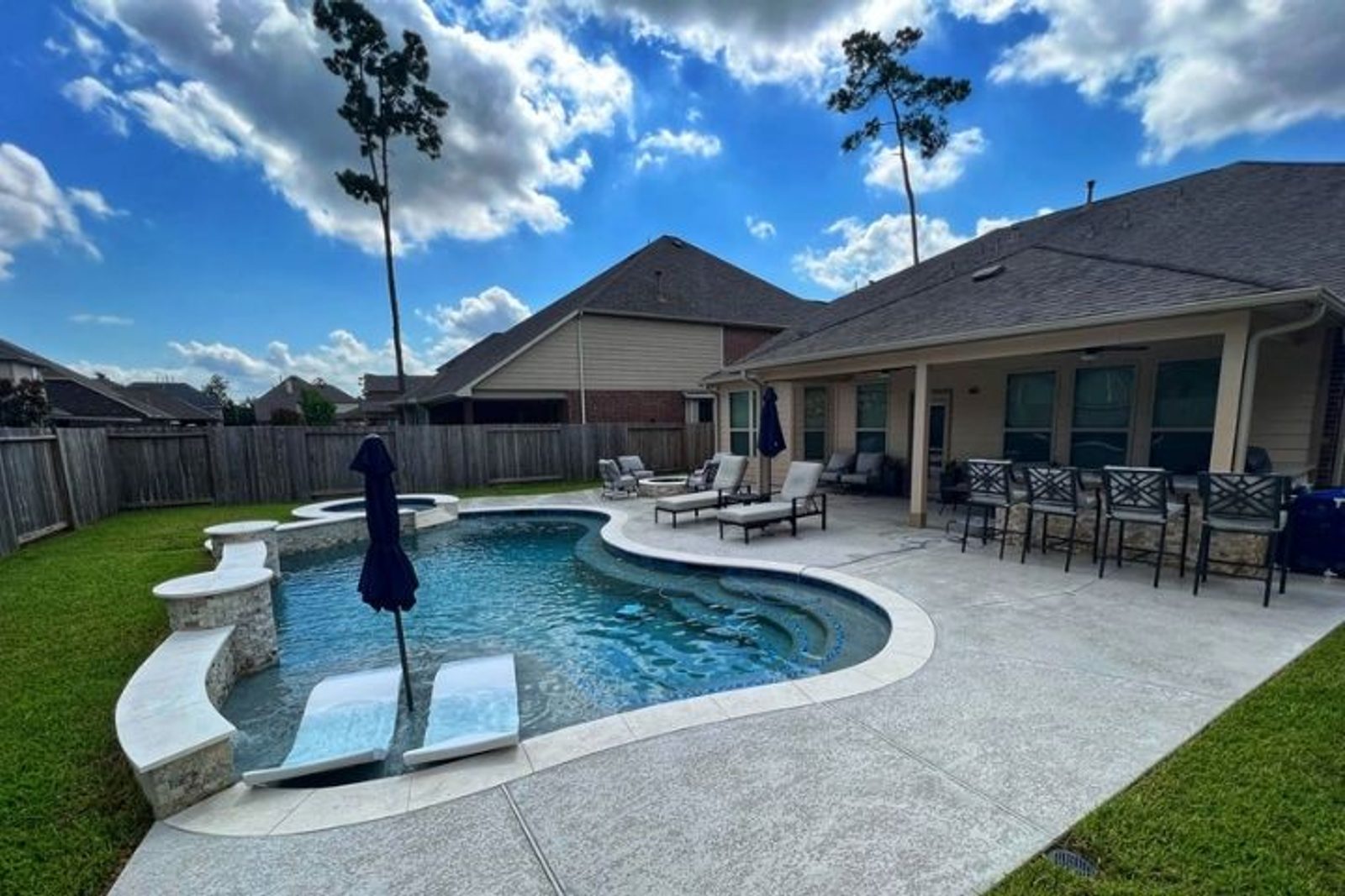Houston Outdoor living area with poolside seating and dining furniture