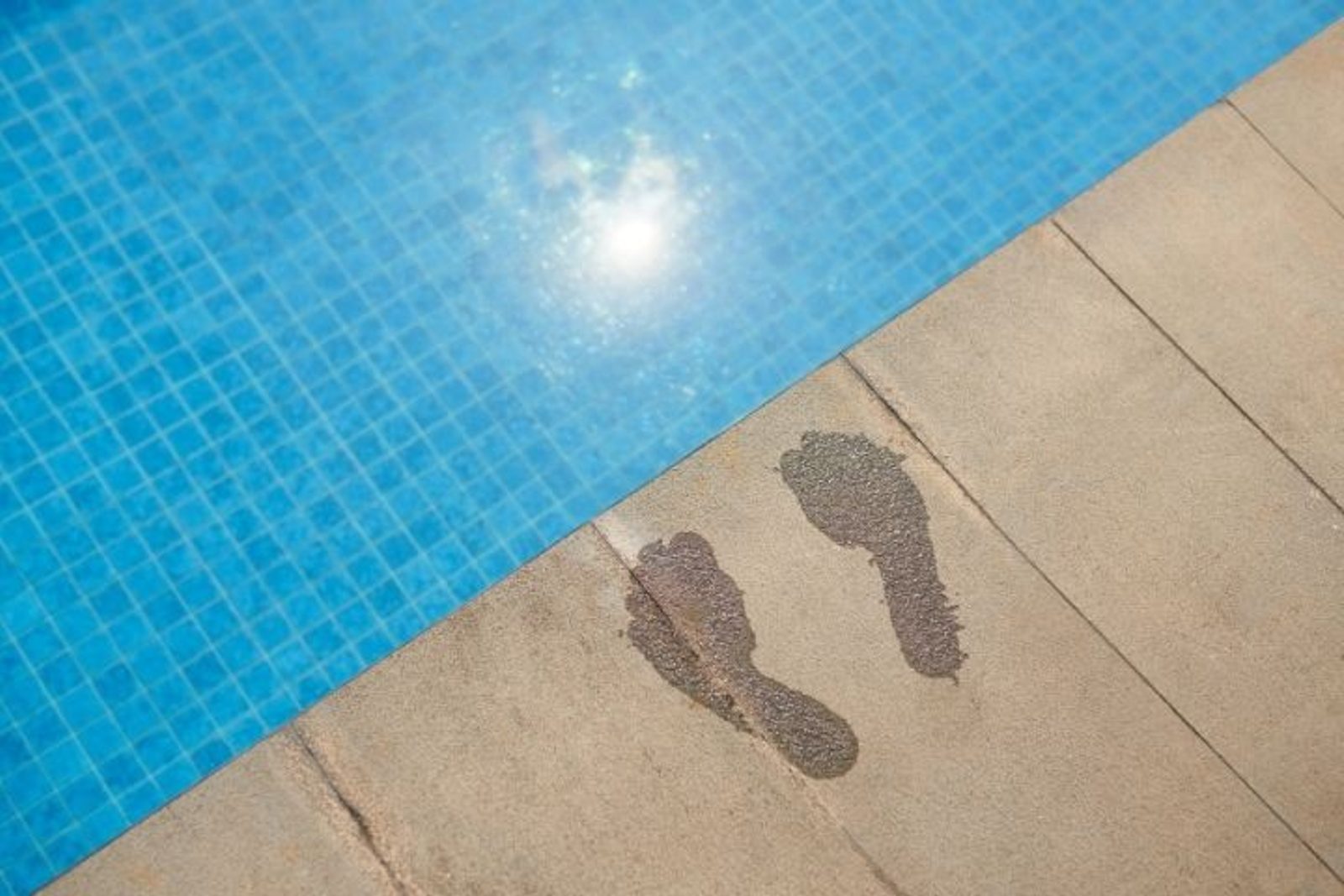 Pool deck beside a swimming pool exposed to intense Houston summer sun and heat