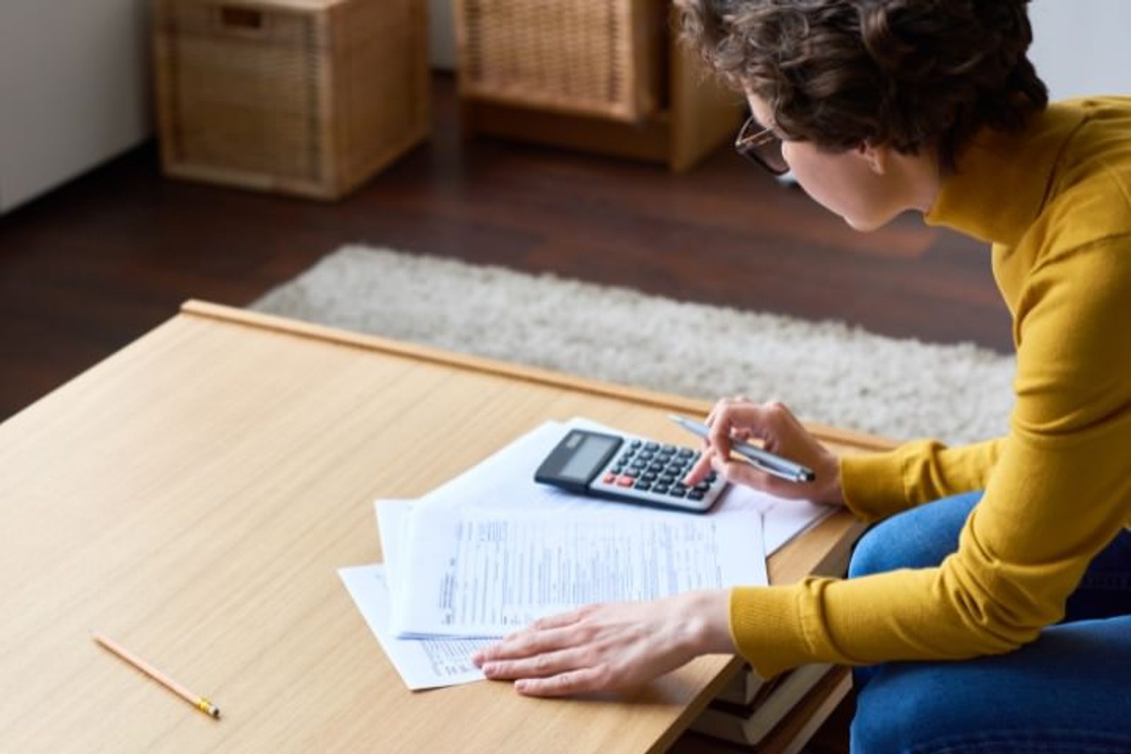 Homeowner calculating expenses and reviewing financing options for a new pool construction project