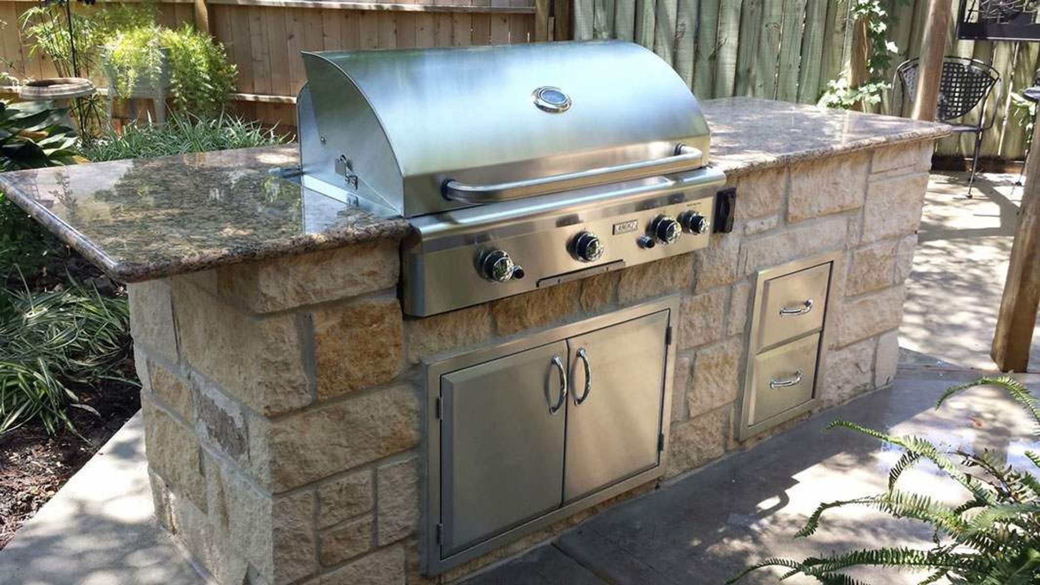 Houston outdoor kitchen with granite countertop and built-in stainless steel grill