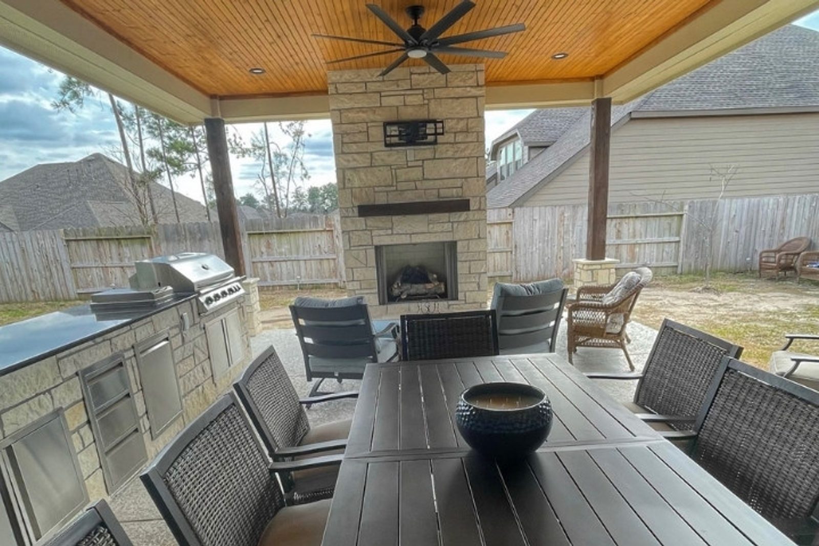 Houston patio layout featuring dining space, grill station, and built-in fireplace