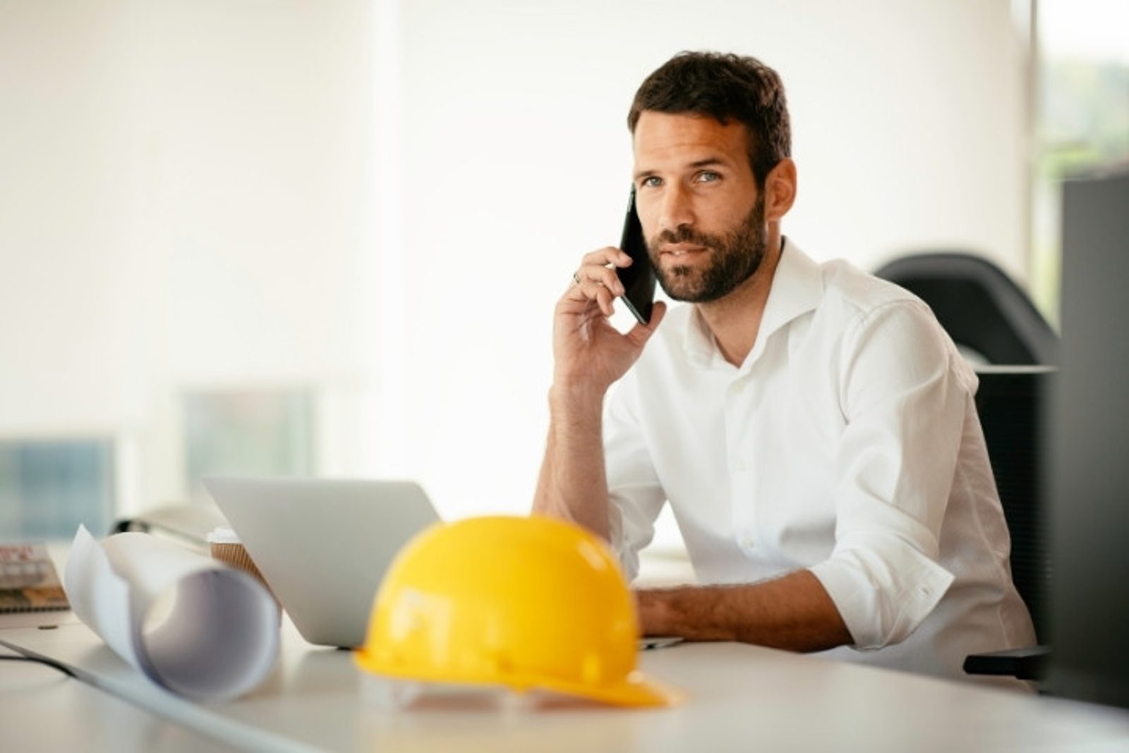 Conroe pool builder on a phone consultation discussing project details with a homeowner