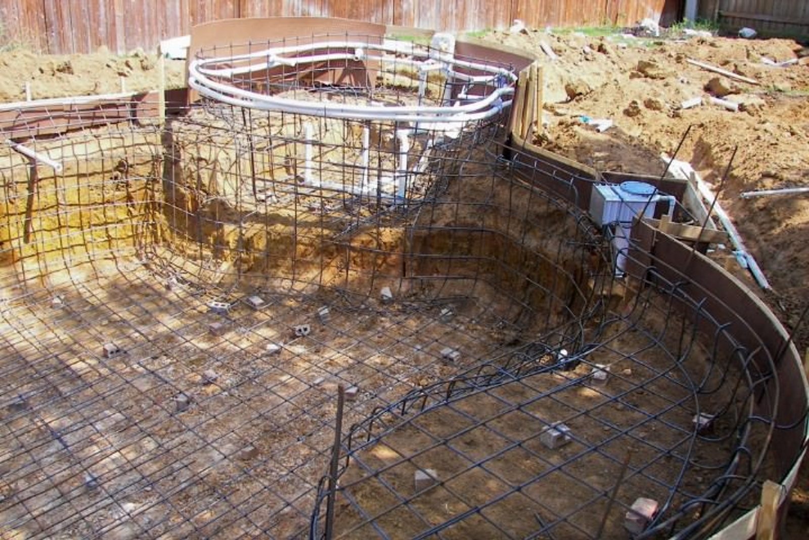 Steel rebar framework forming structural base of in-ground pool