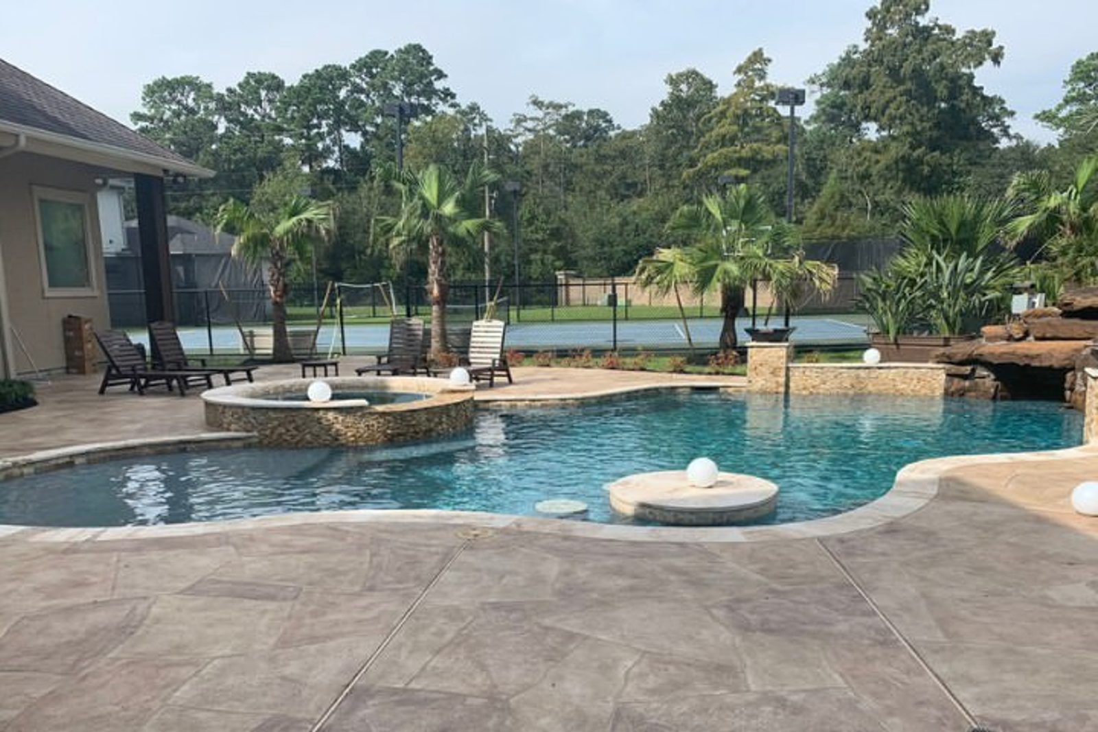 Luxury custom pool with tropical landscaping and integrated spa