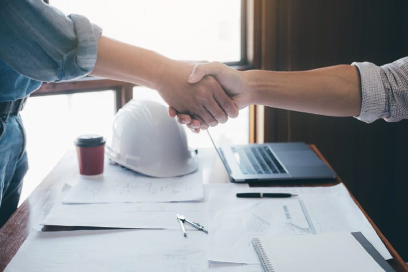 Homeowner and pool builder closing a deal with a handshake