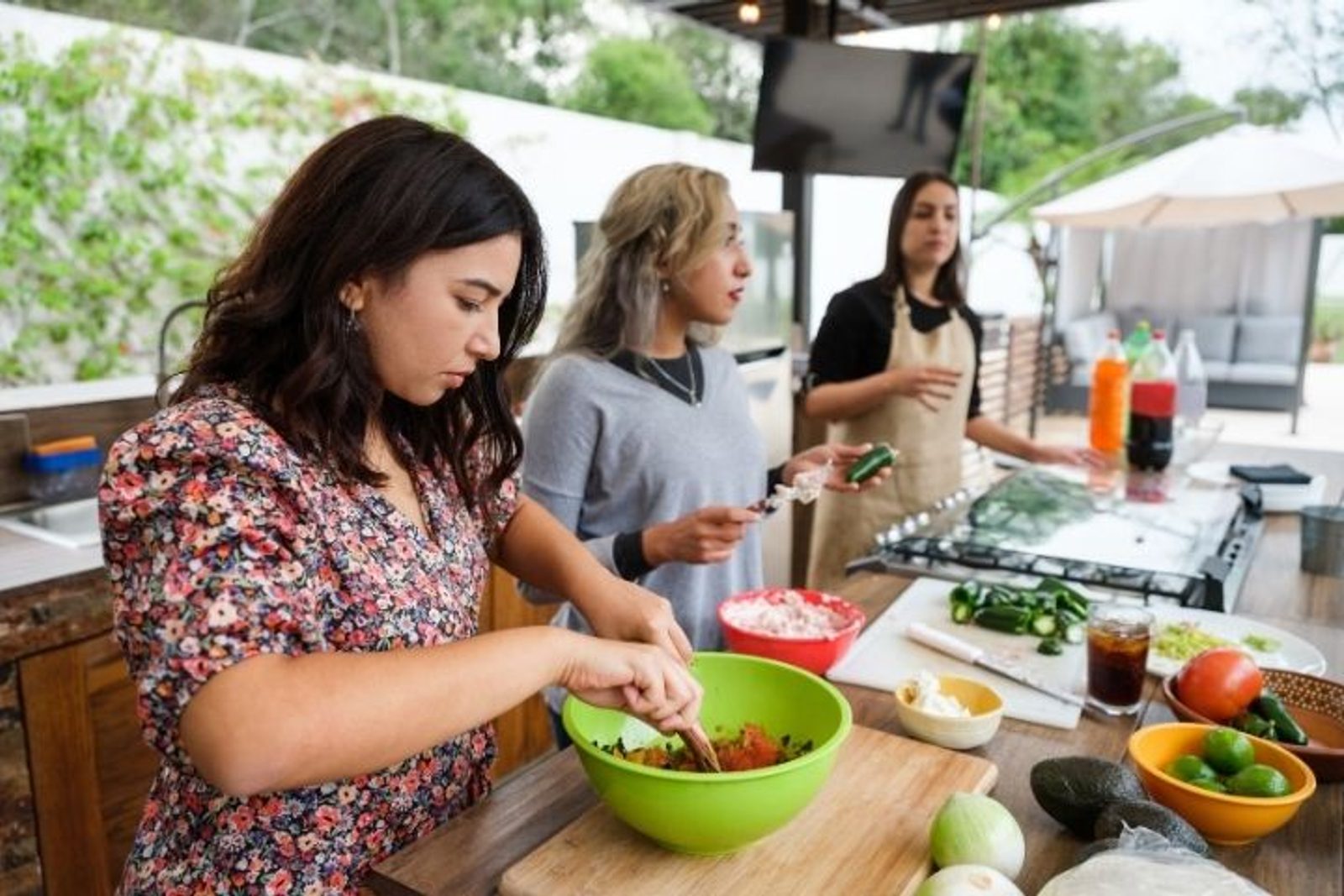 Multiple cooking and preparation zones showing an efficient custom outdoor kitchen workflow