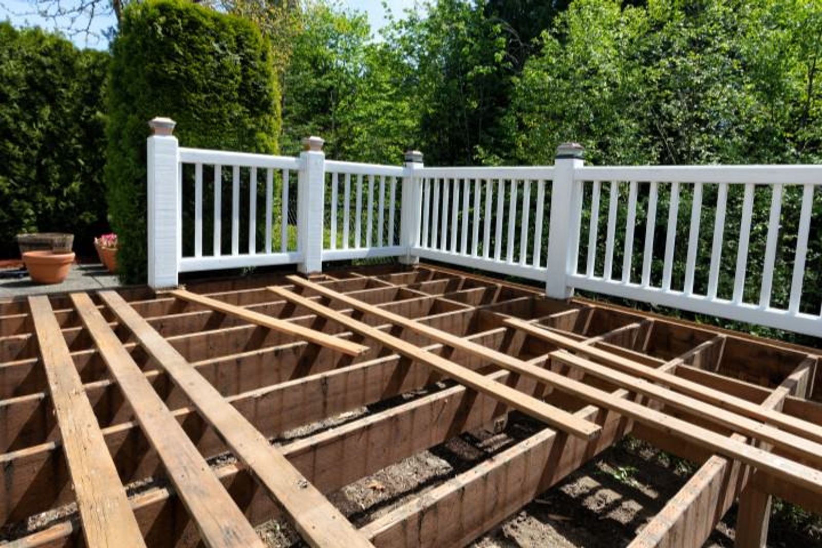 Outdoor deck construction in progress, showing wooden framework for a custom-built patio