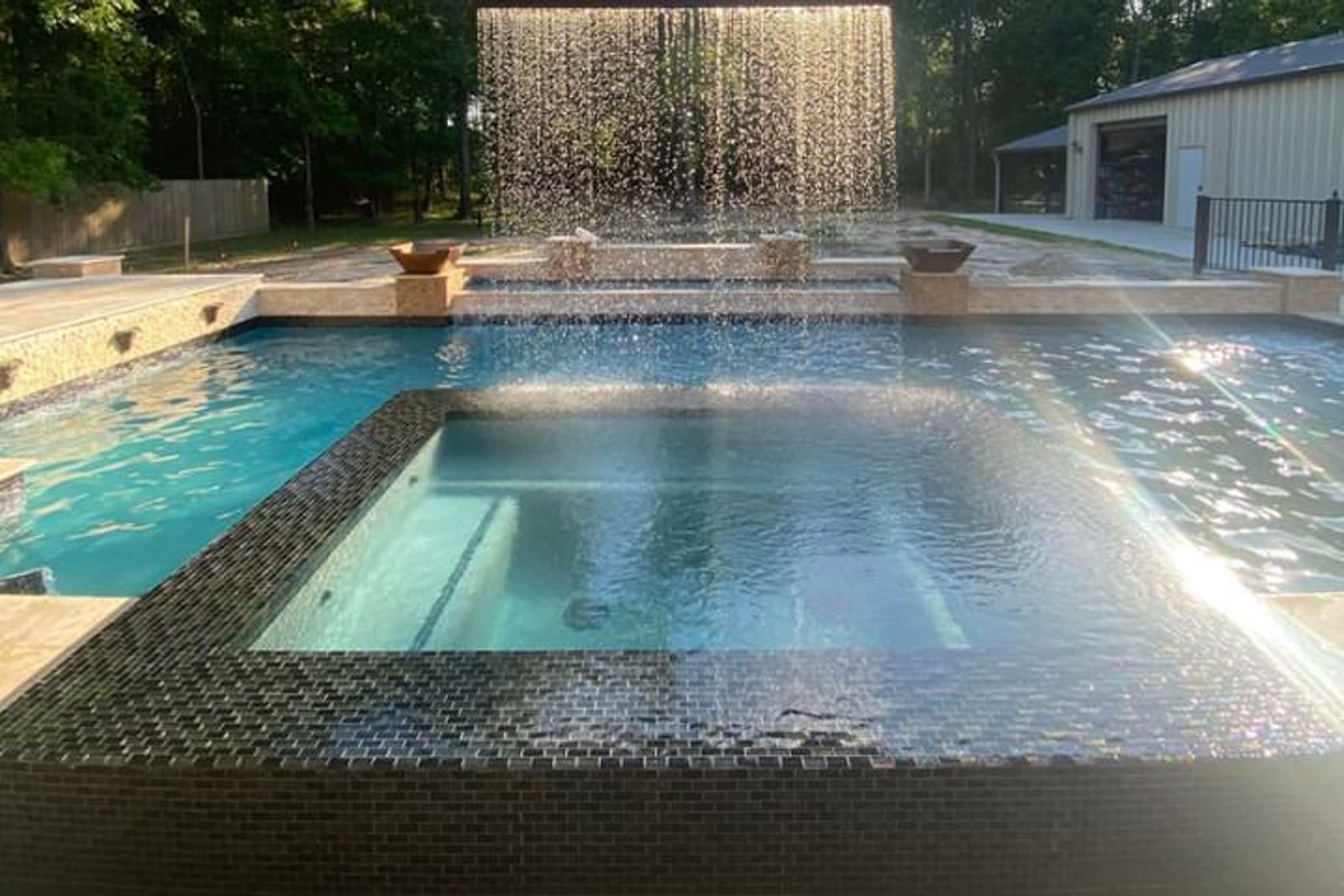Raised luxury pool spa with waterfall feature