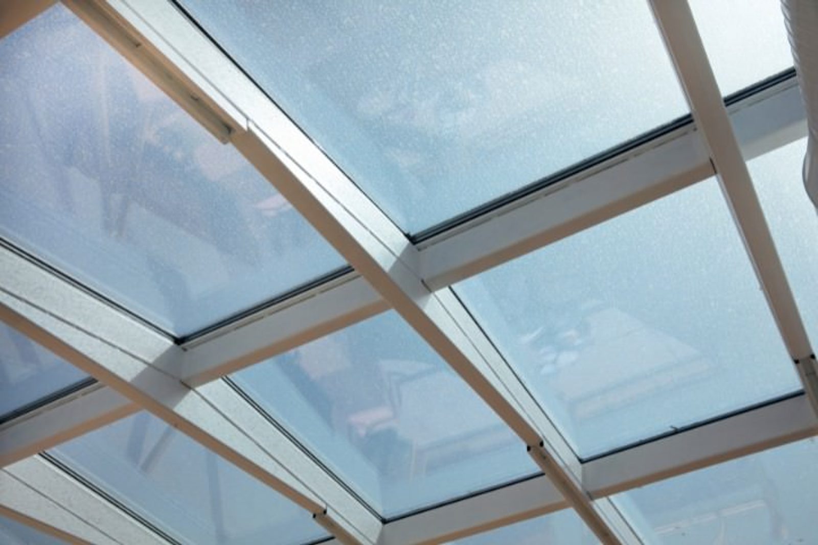 Weatherproof glass patio cover designed to provide clear protection from Houston’s changing weather