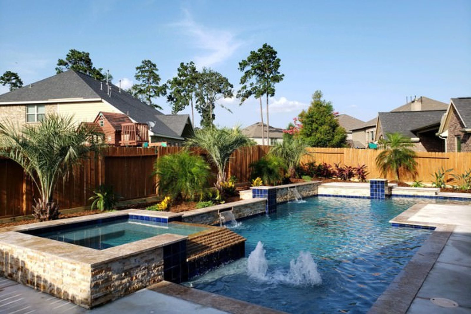 Balanced outdoor space landscaping around custom pool