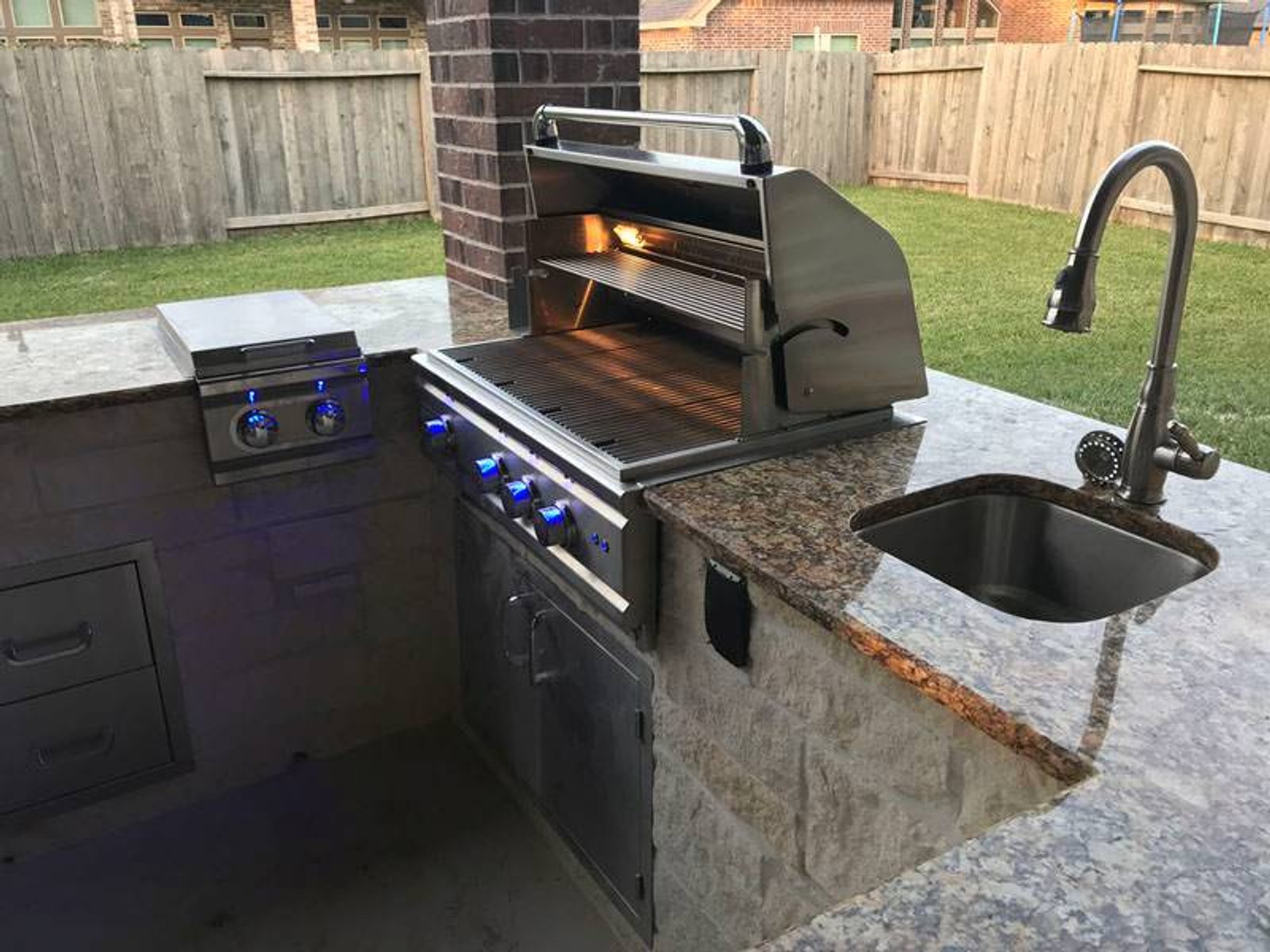 Houston outdoor kitchen with a high-end grill, compact sink, and granite countertop