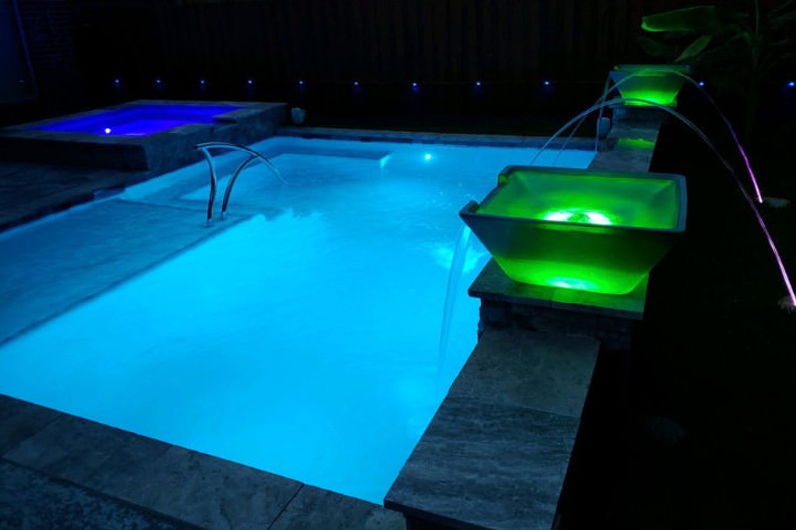 Houston pool with modern fire and water bowls, creating a dramatic visual contrast