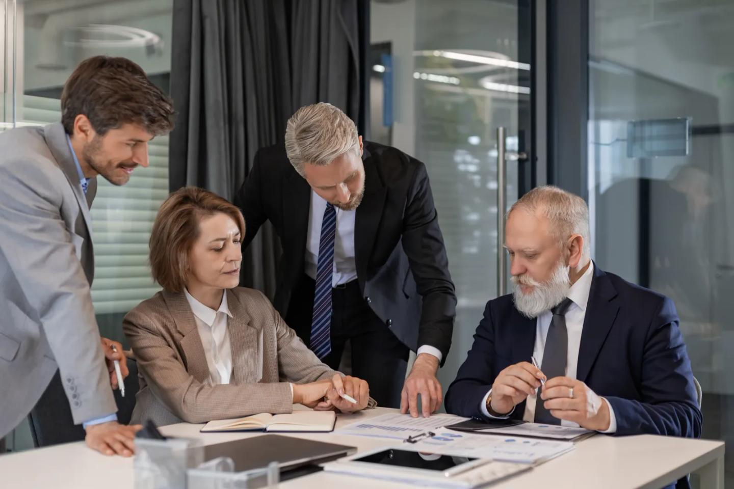 Advisors reviewing program documents with university leaders.