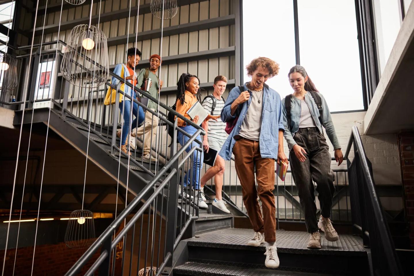Students walking down a busy campus staircase.