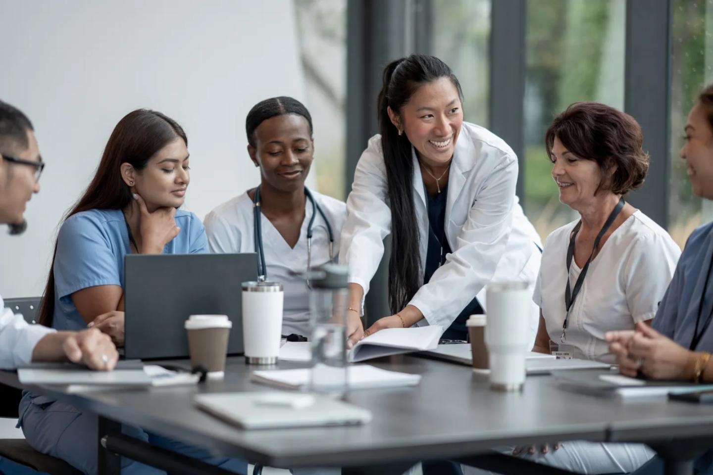 A medical team collaborating around a meeting table.