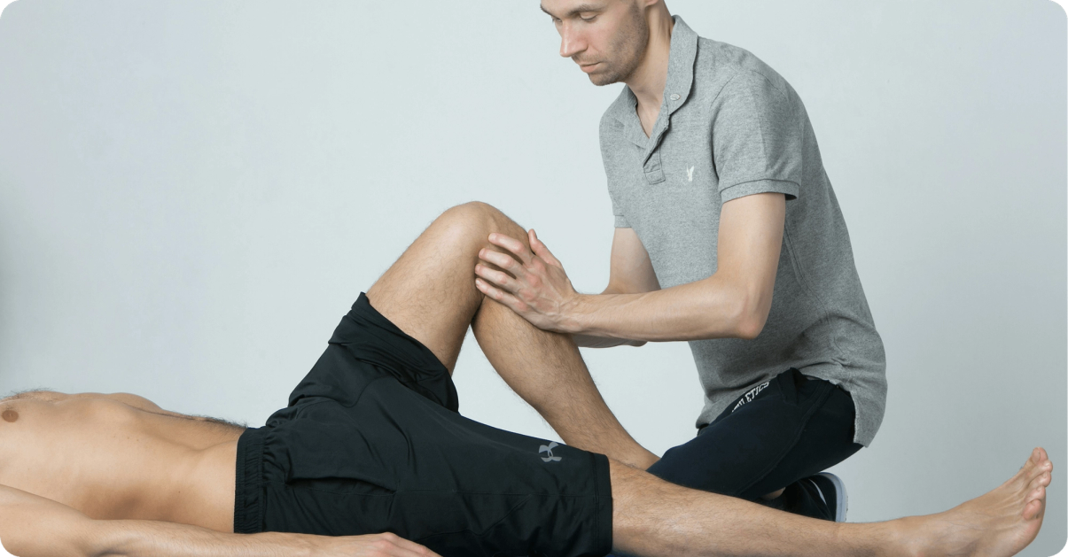 Chiropractor examining a patient's knee