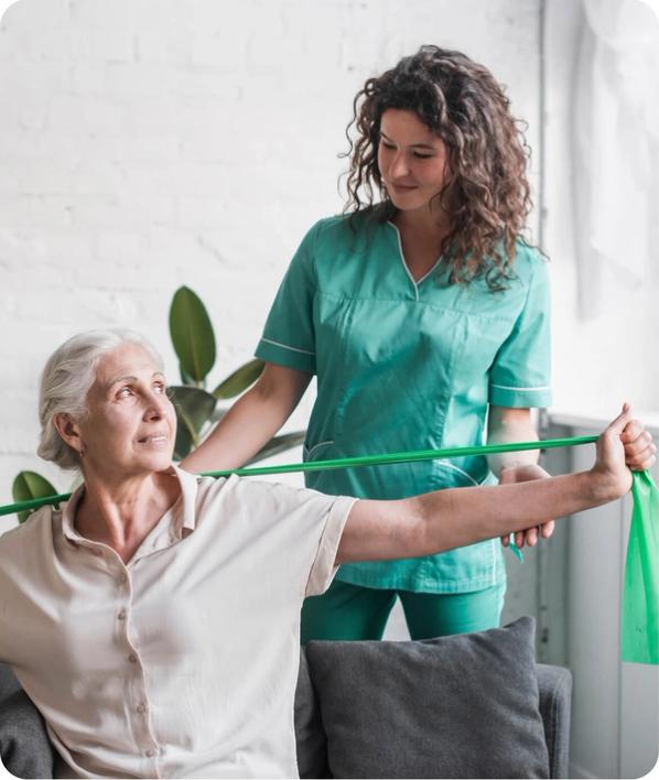 Senior woman with stretch band being assisted