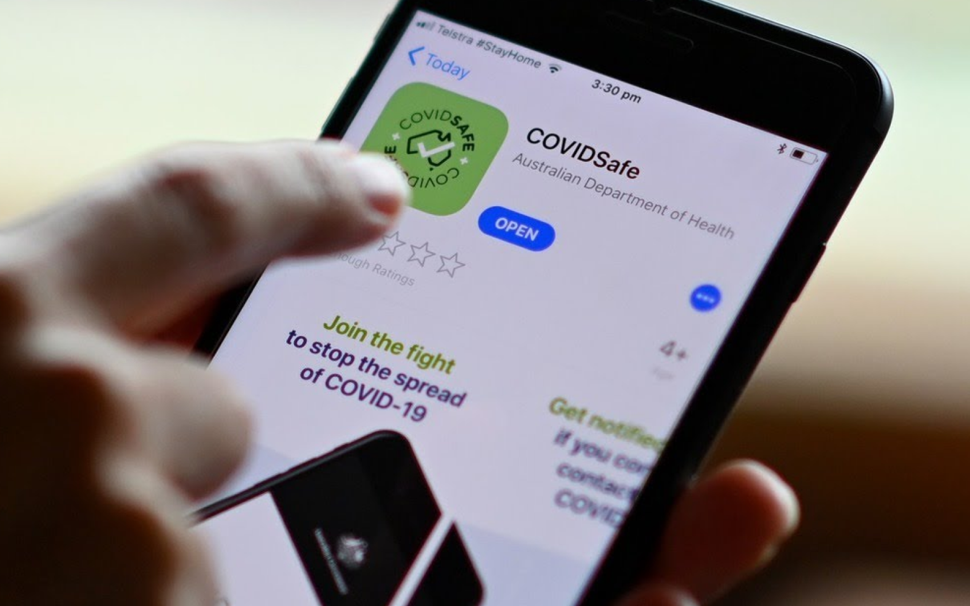 close up of a man using covid safe app