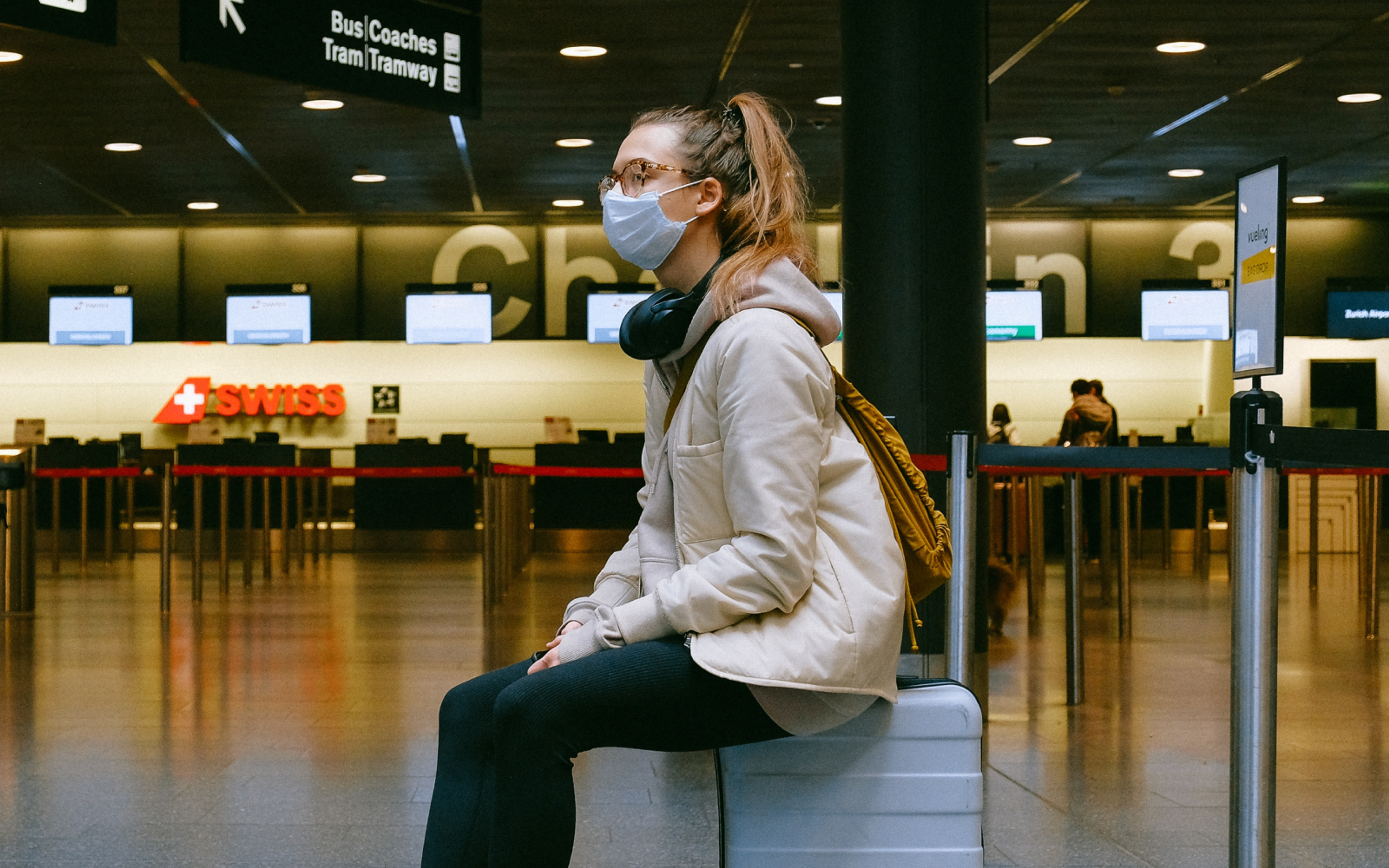 Woman Sitting on Luggage