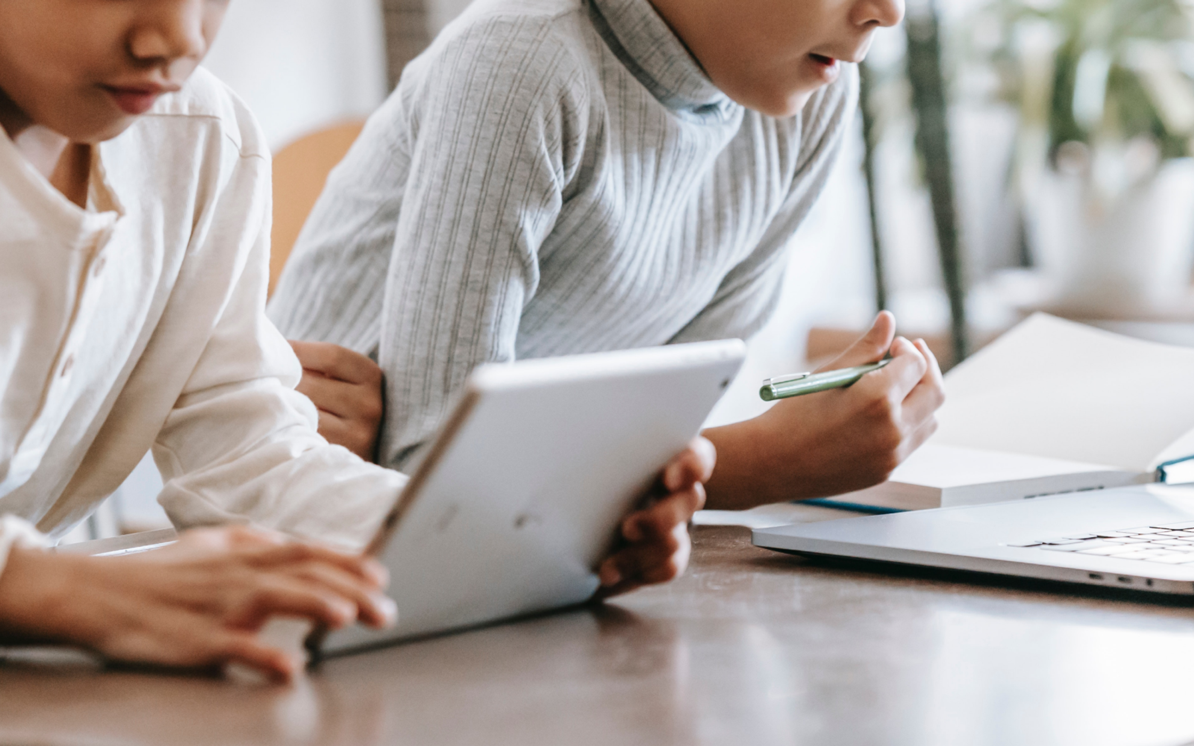 Concentrated children using laptop and tablet at home