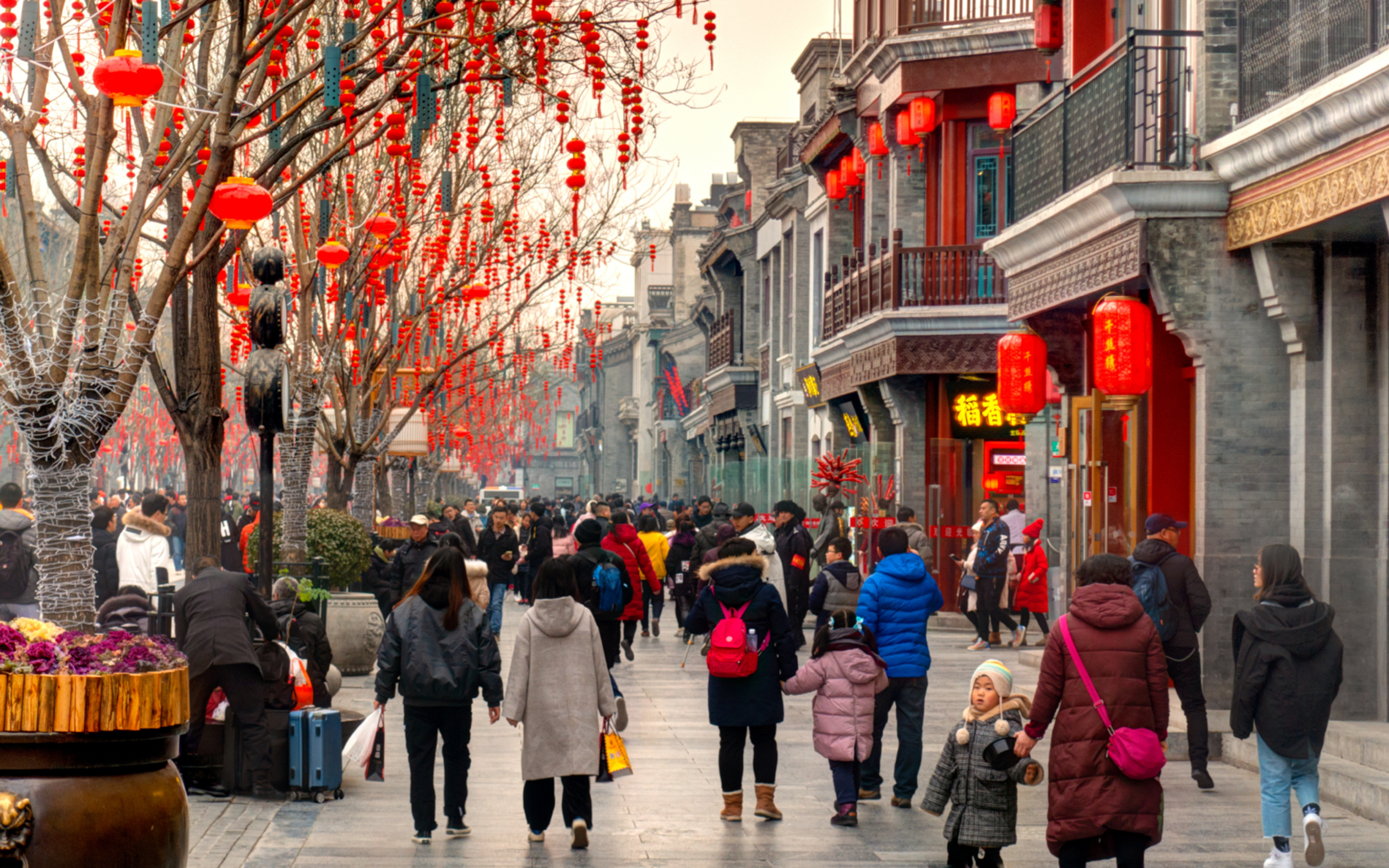 Chinese people walking through Qianmen district, Beijing, China