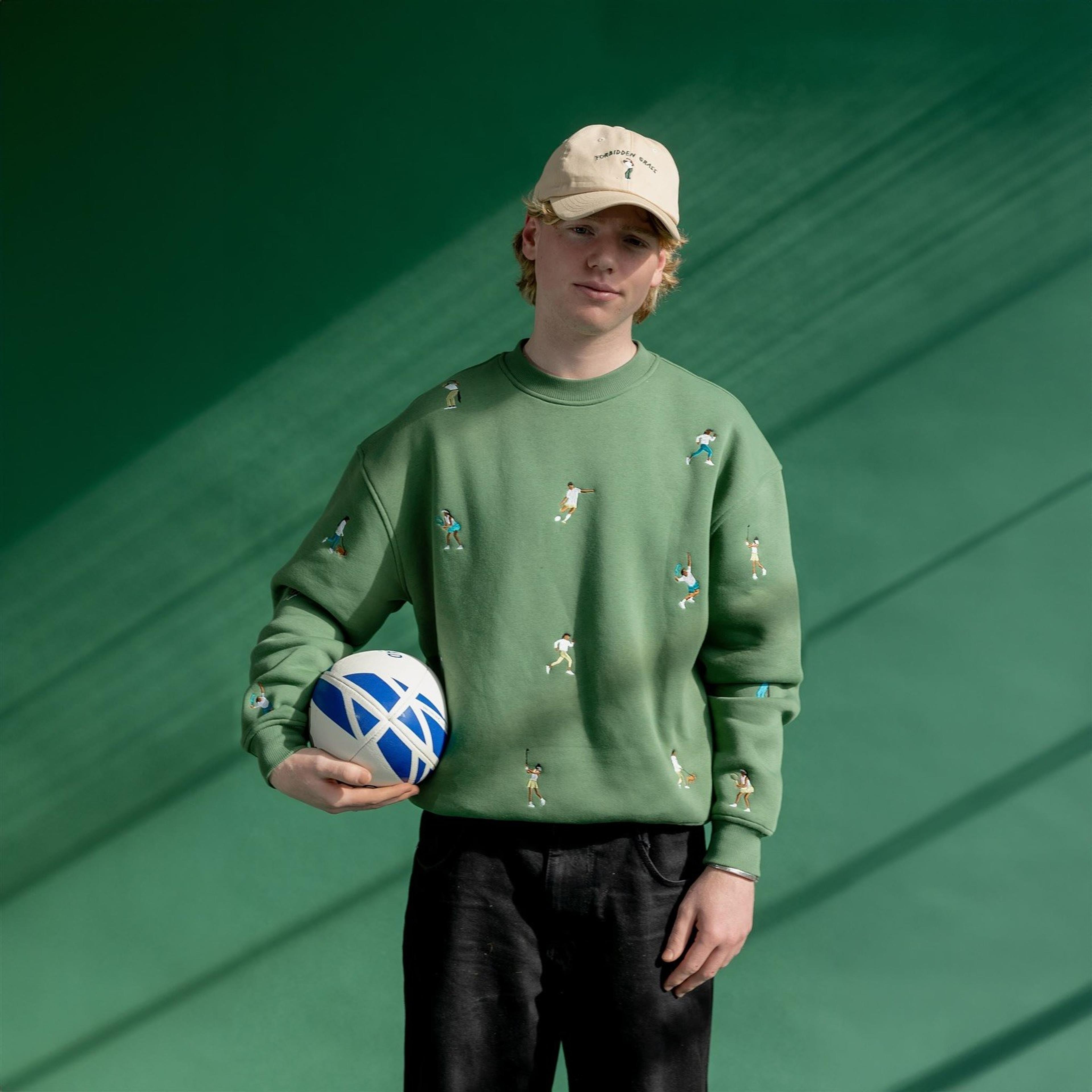 Image of model wearing green custom merch jumper by artist Werner Bronkhorst.