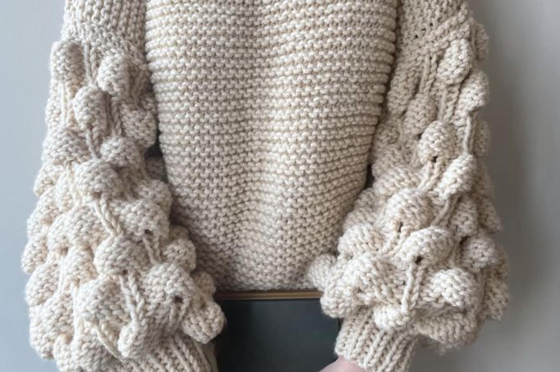 Example of a chunky knit sweater with textured sleeves.