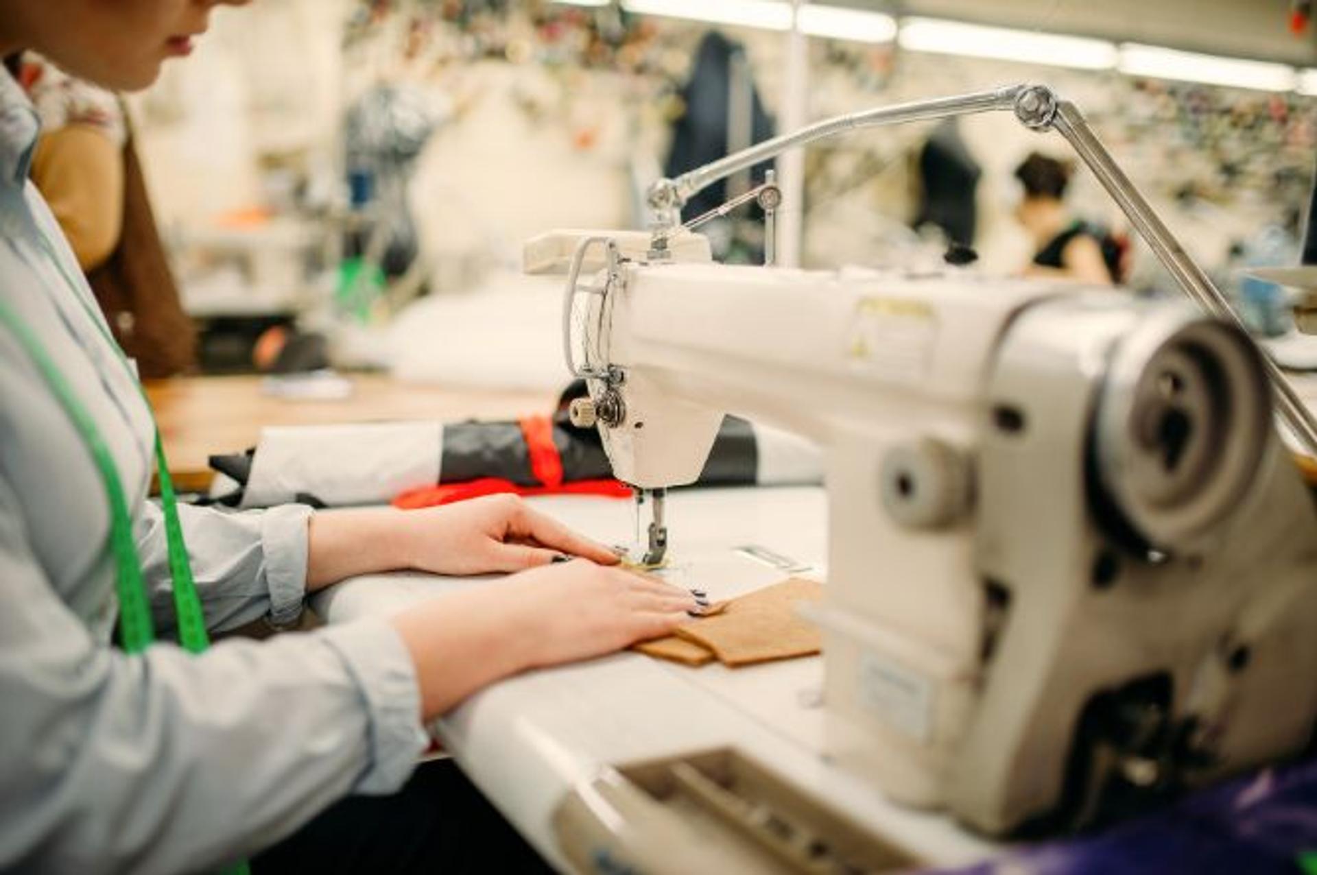 A person at the sewing machine. 