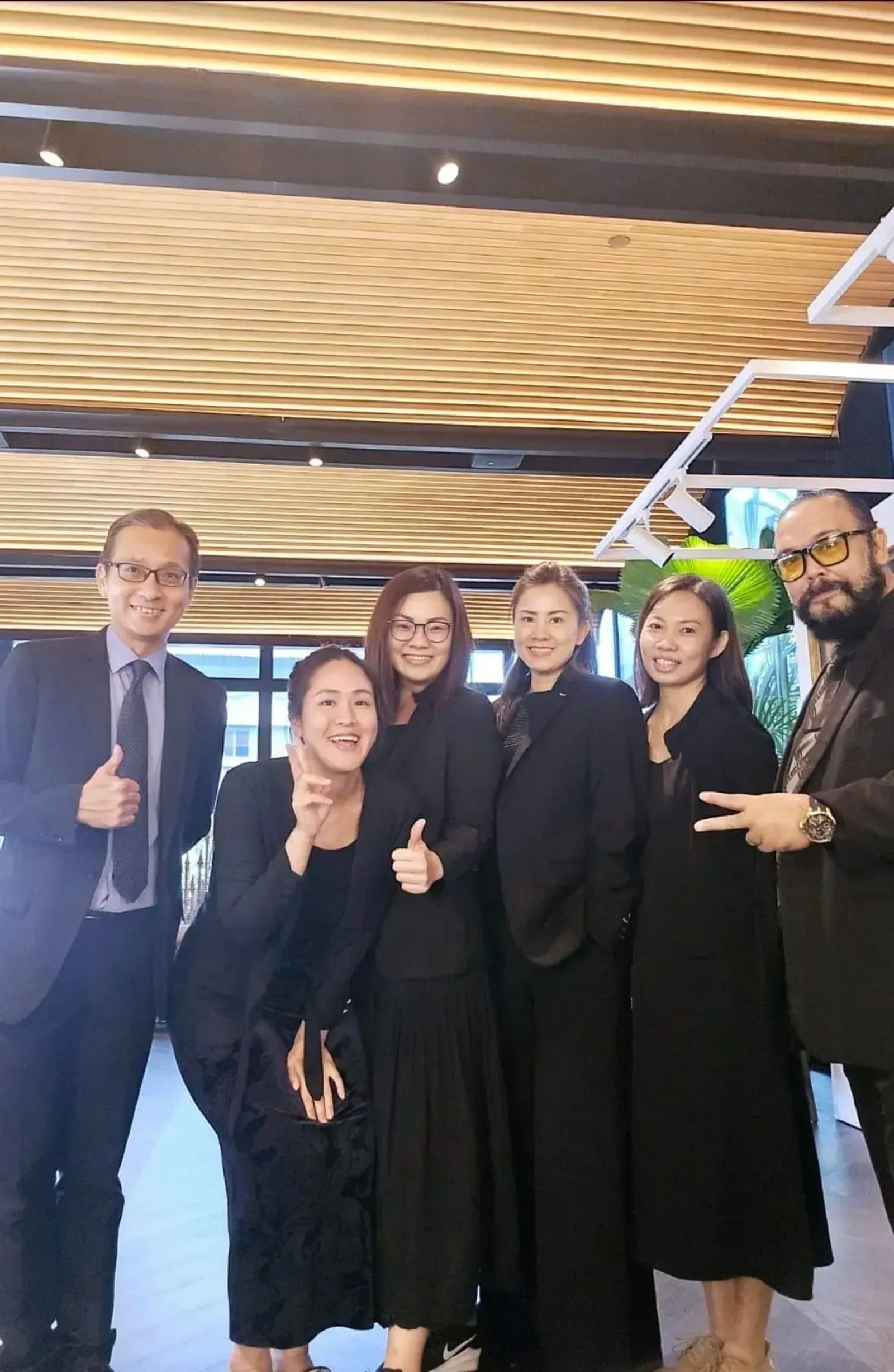 SSIS team in formal attire at a watch display