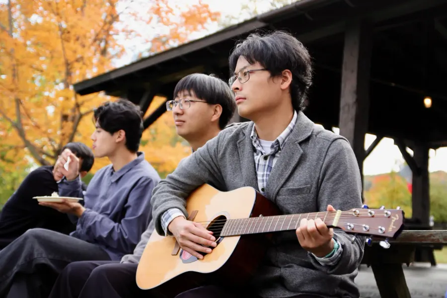 FICCC members singing with guitar outdoors