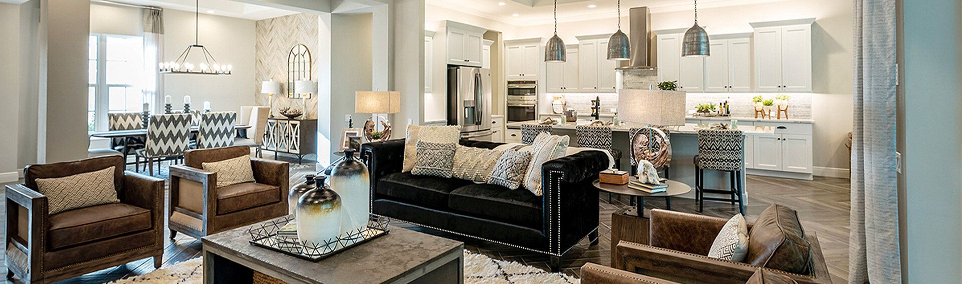 Open-concept living room and white kitchen in Sam Rodgers model
