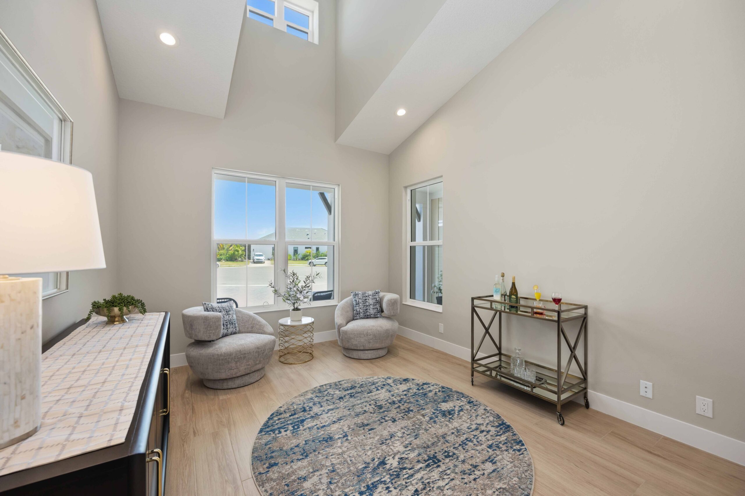 Bright sitting room with vaulted ceiling and swivel chairs