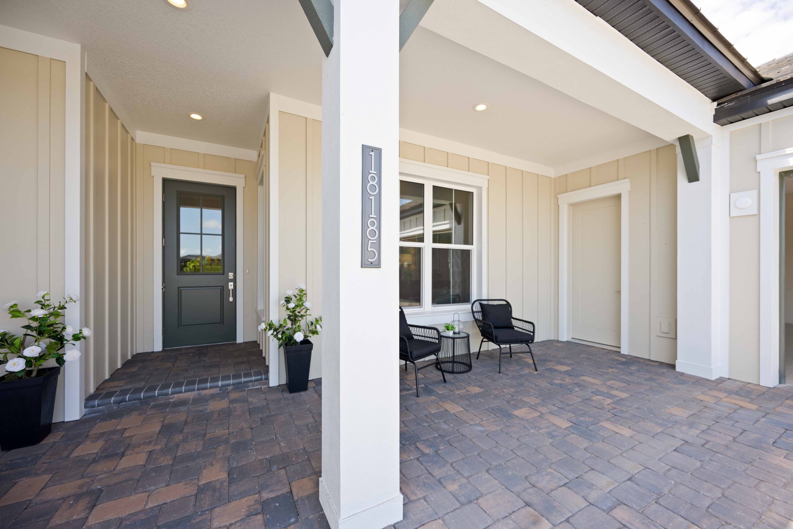 Covered front porch with seating at Destin model