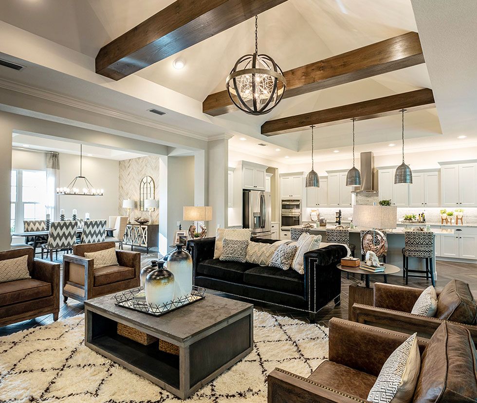 Open-concept great room with wood beams and designer kitchen
