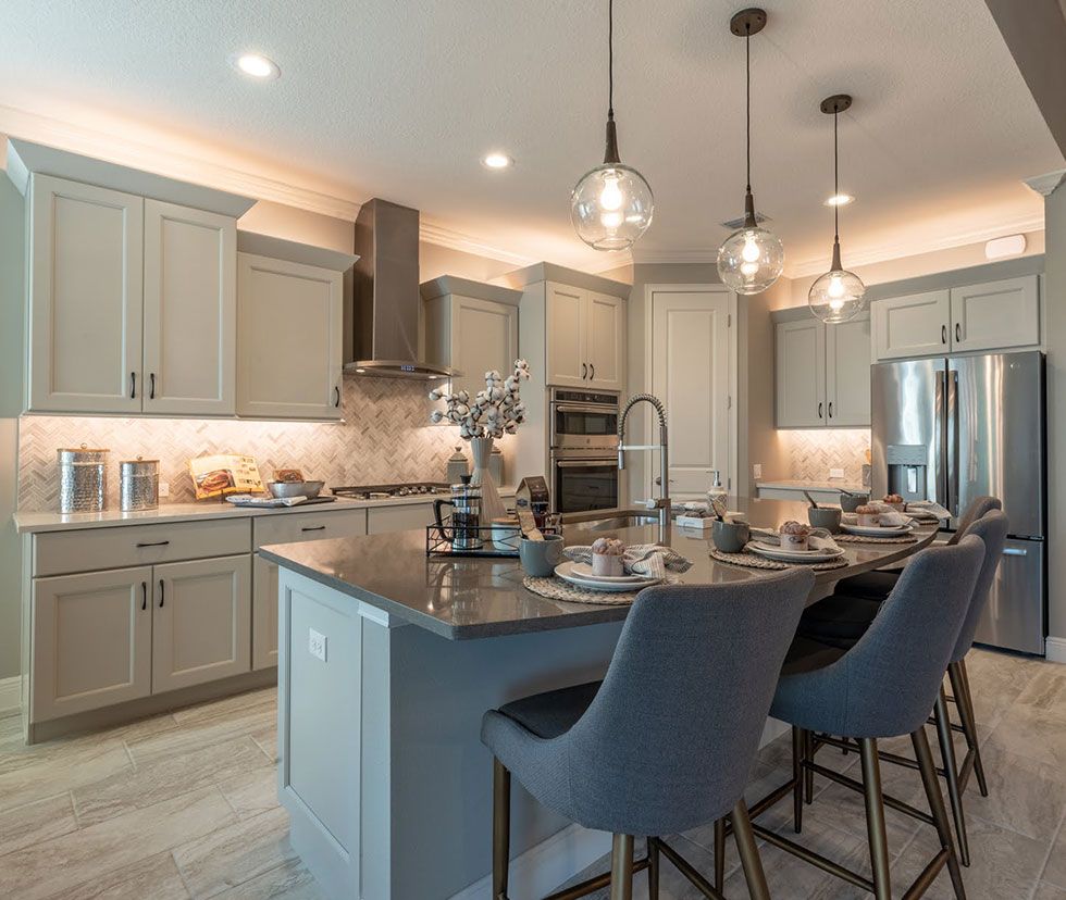Designer kitchen with island seating and pendant lighting